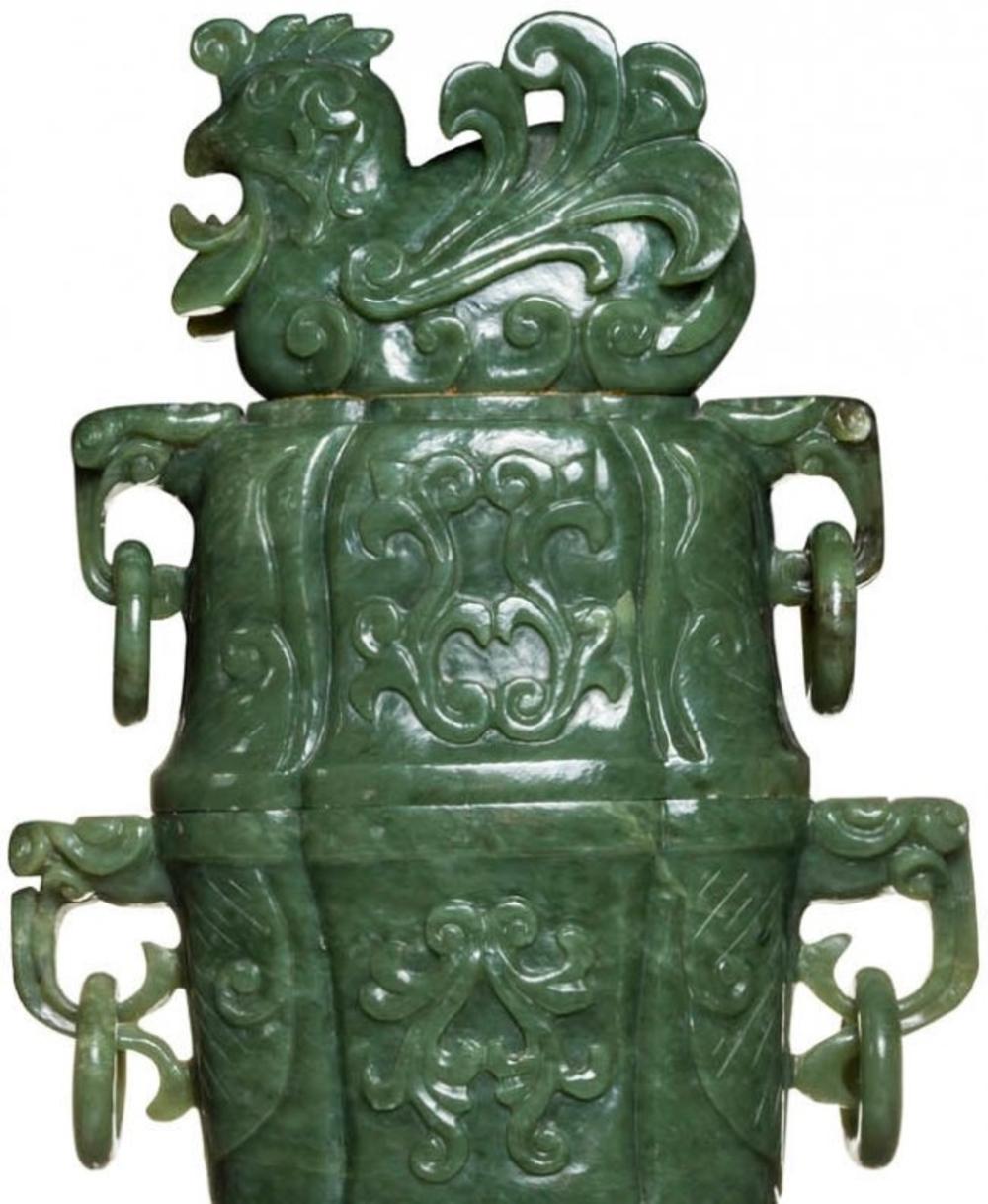 Very large Chinese carved jade vases and covers
Each carved in relief with scroll detail, flanked by mask
Handles supporting loose rings, the conforming cover flanked by loose rings and surmounted by a bird finial.
Measures: Height 28 in. (71.12