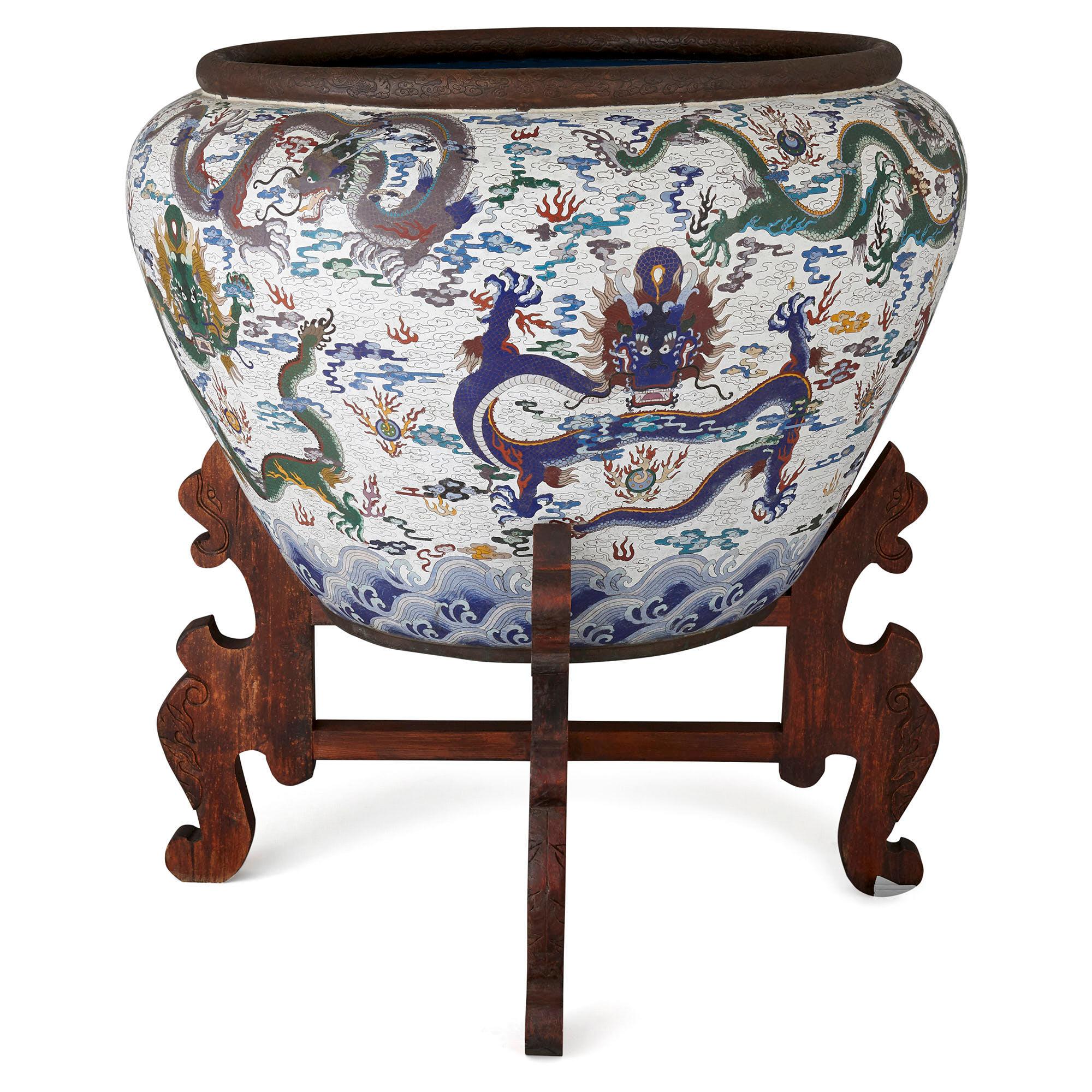 Very large Chinese enamel jardinière on hardwood stand
Chinese, 20th century
Measures: Height 127cm, diameter 116cm

This exceptionally large cloisonné enamel jardinière is a superb example of 20th century Chinese design. The jardinière is of