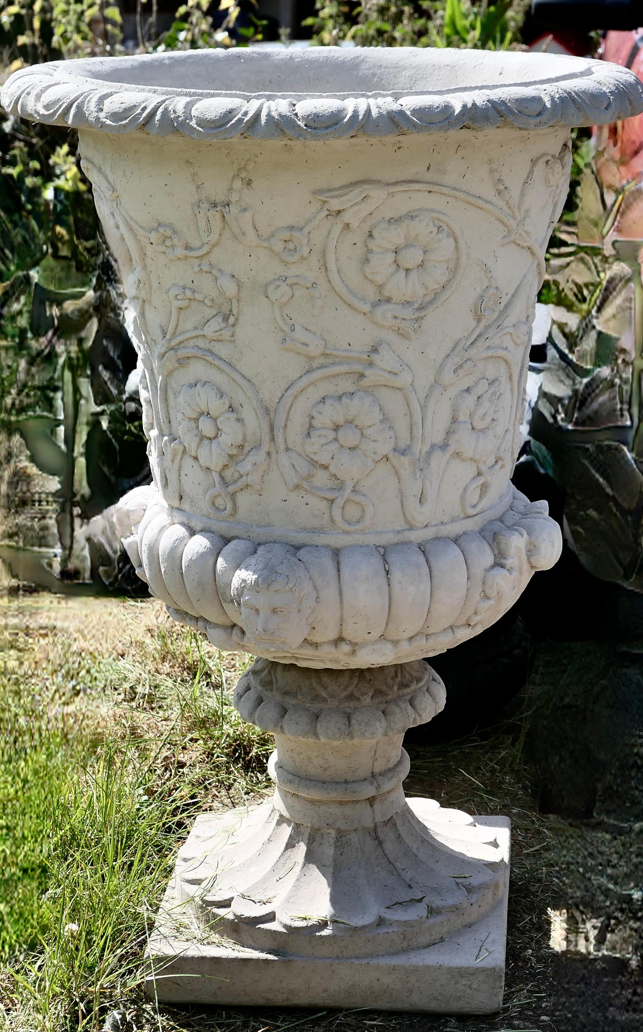 Very large classical Tudor rose garden planter 

A large 2 piece garden planter, decorated with entwining grape vines and bunches of grapes. 
The urn is lightly weathered and has a drainage hole in the centre
Measures: The urn is 35” tall and