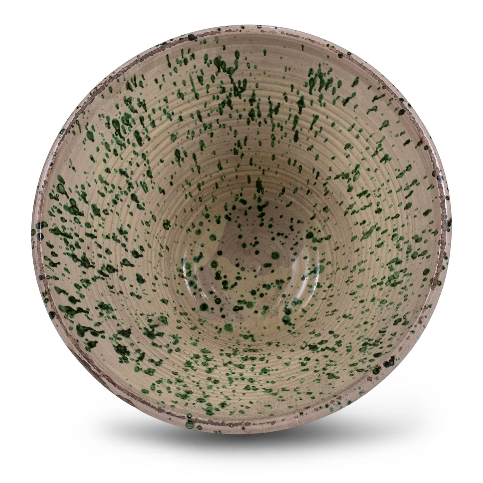 Very large colorful glazed earthenware passata bowl from Southern Italy (Puglia). This rustic 19th century terracotta bowl was used in the Italian countryside to make tomato passata. Handcrafted and glazed in a pesto-color green pattern over