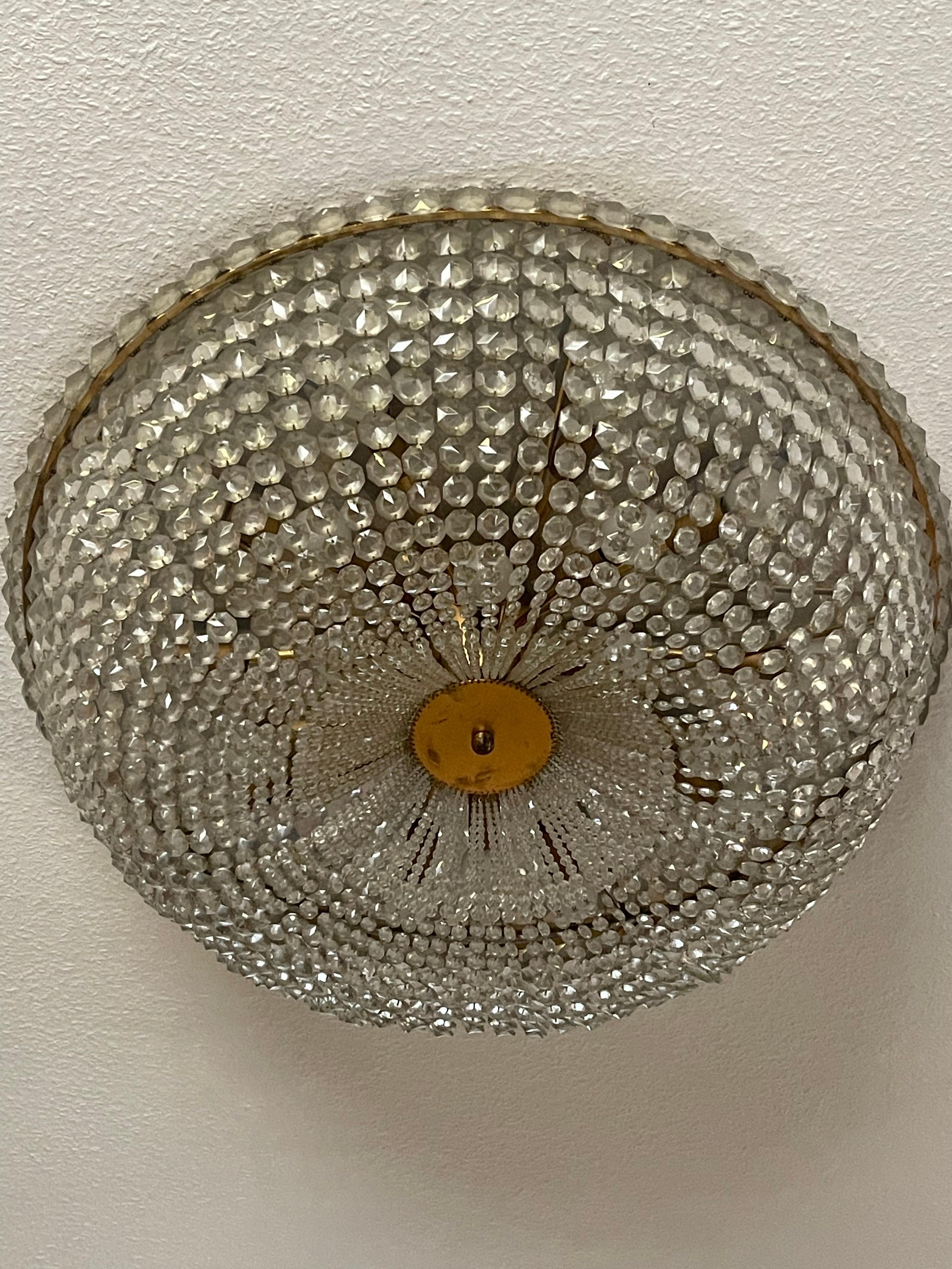 A very large twenty-light crystal and brass flush mount attr. to Lobmeyr or Bakalowits, Austria, ca. 1970s.
Socket: 20x e14 for standard screw bulbs.
Measures: Diameter: 29.92 inches.