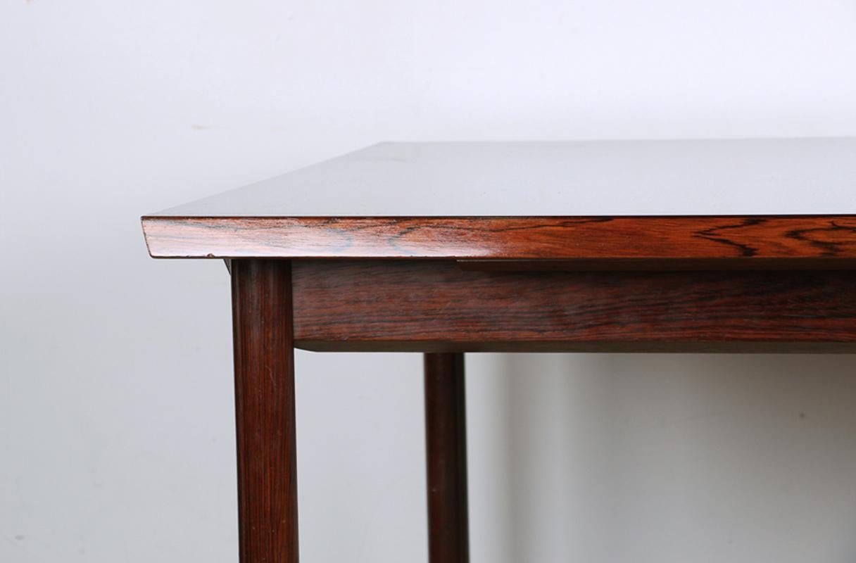 Magnificent large Scandinavian dining room table.
 Rectangular in shape, two extensions of 50 cm each are stored below to provide space for 10/12 people. 
Beautifully crafted piece of furniture with a sober and very elegant modernist design. 
Superb