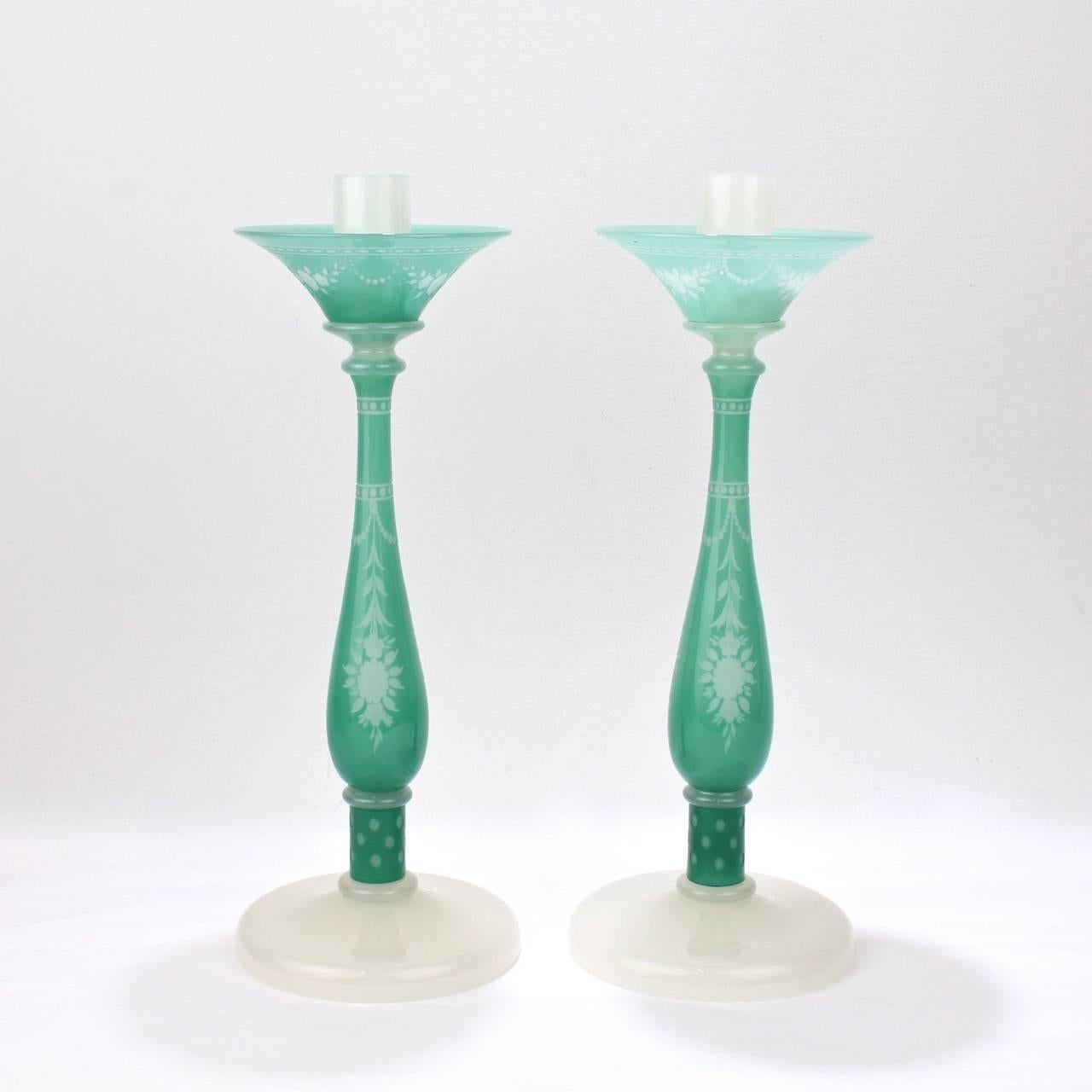 A very fine, large pair of Steuben candlesticks in the rare York pattern.

Alabaster white and jade green glass with wheel-cut decoration,

circa 1930s.

Bases each bear a fleur-de-lis acid etched Steuben factory mark.

Height: ca. 14 1/2