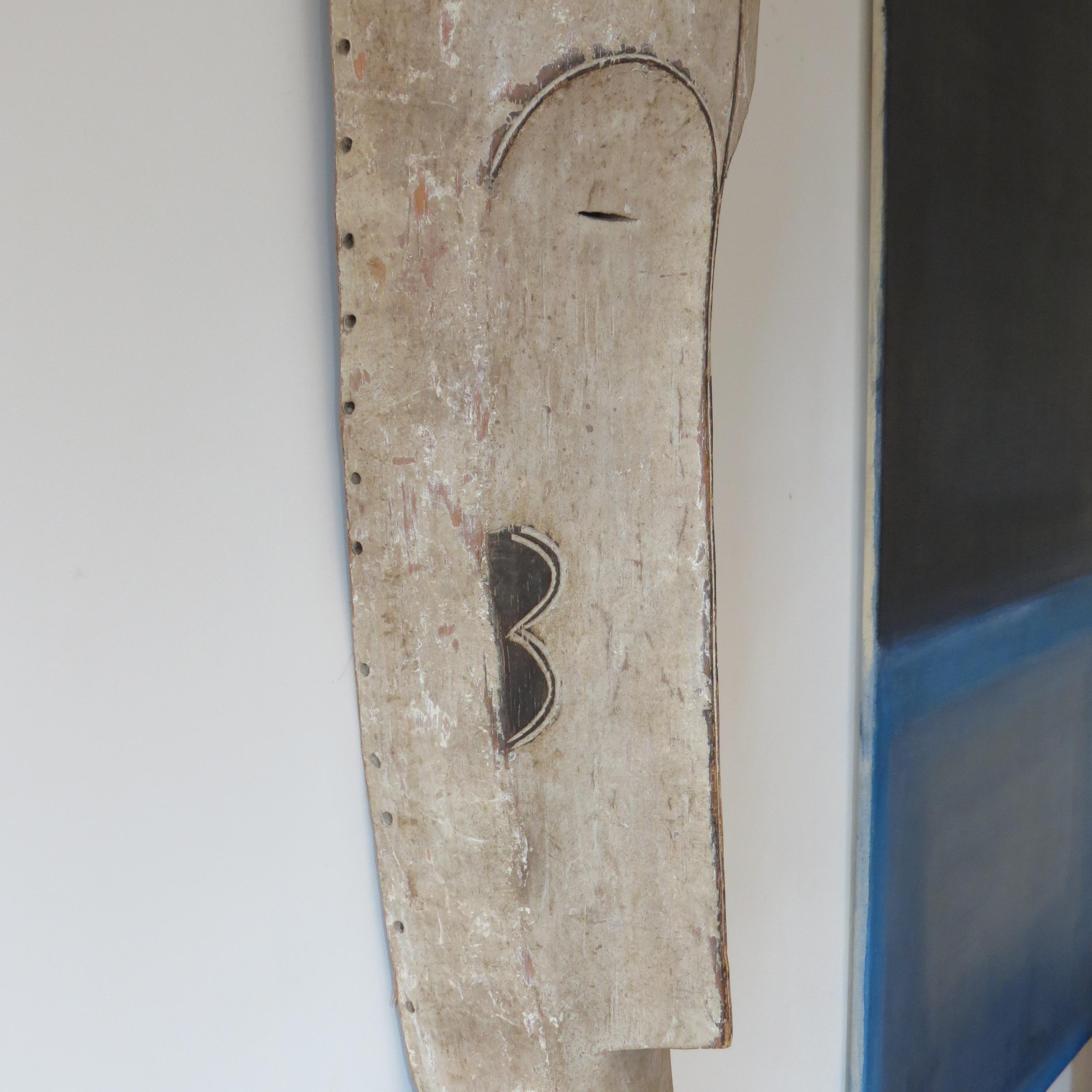 A wonderful, very large elongated Tribal fang mask from Gabon. 
Hand carved and hand painted using tempura paint. 
Used in ceremonies, the mask has very nice detail to it and makes a striking wall hanging.  
Holes to the edge of the mask would