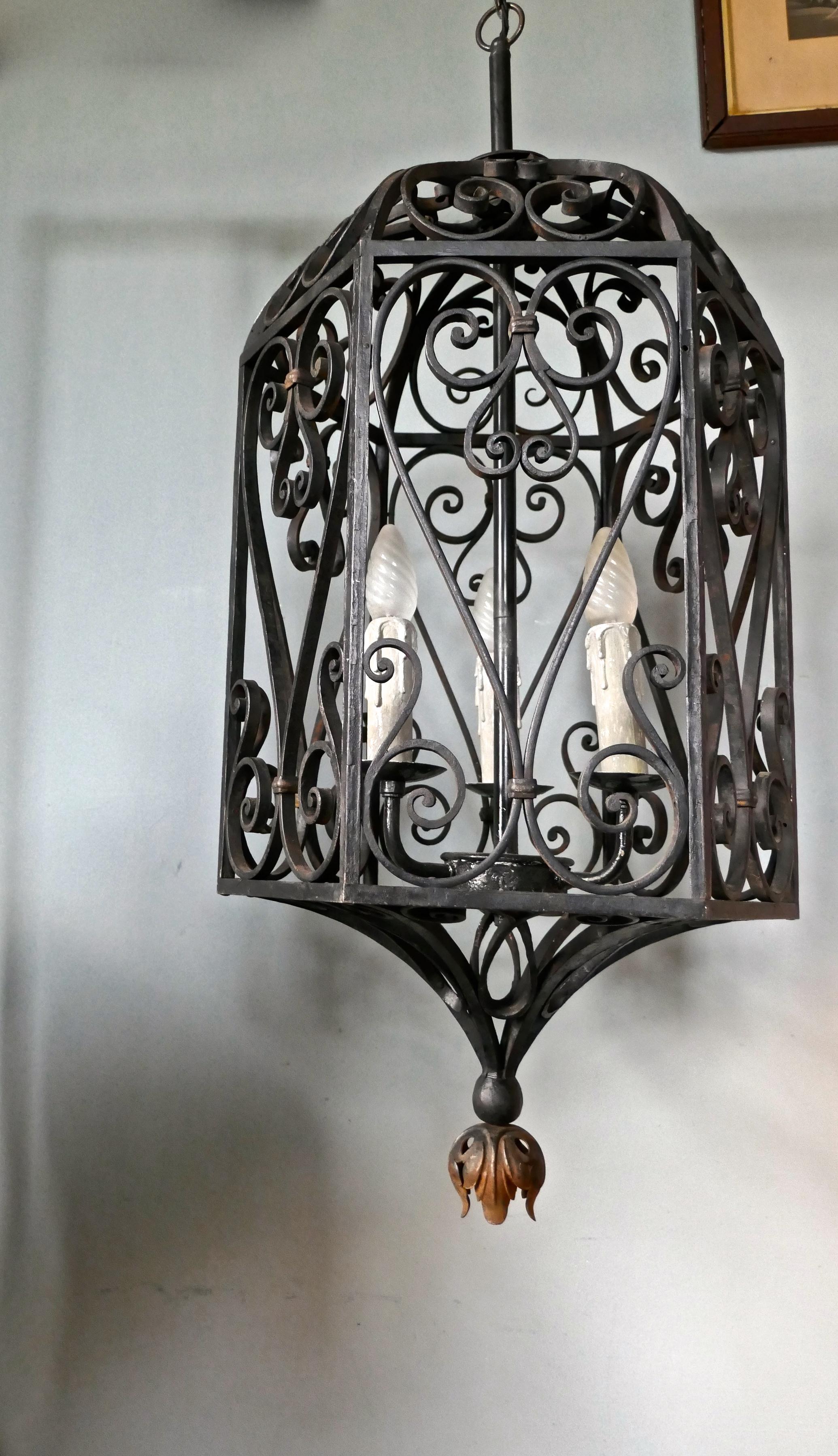 Very large decorative wrought iron porch lantern

This is a very large hallway or porch lantern has six sides, an arched top and a leaf decoration at the bottom
The decorative iron work is over 1 cm thick making the lantern very sturdy and a