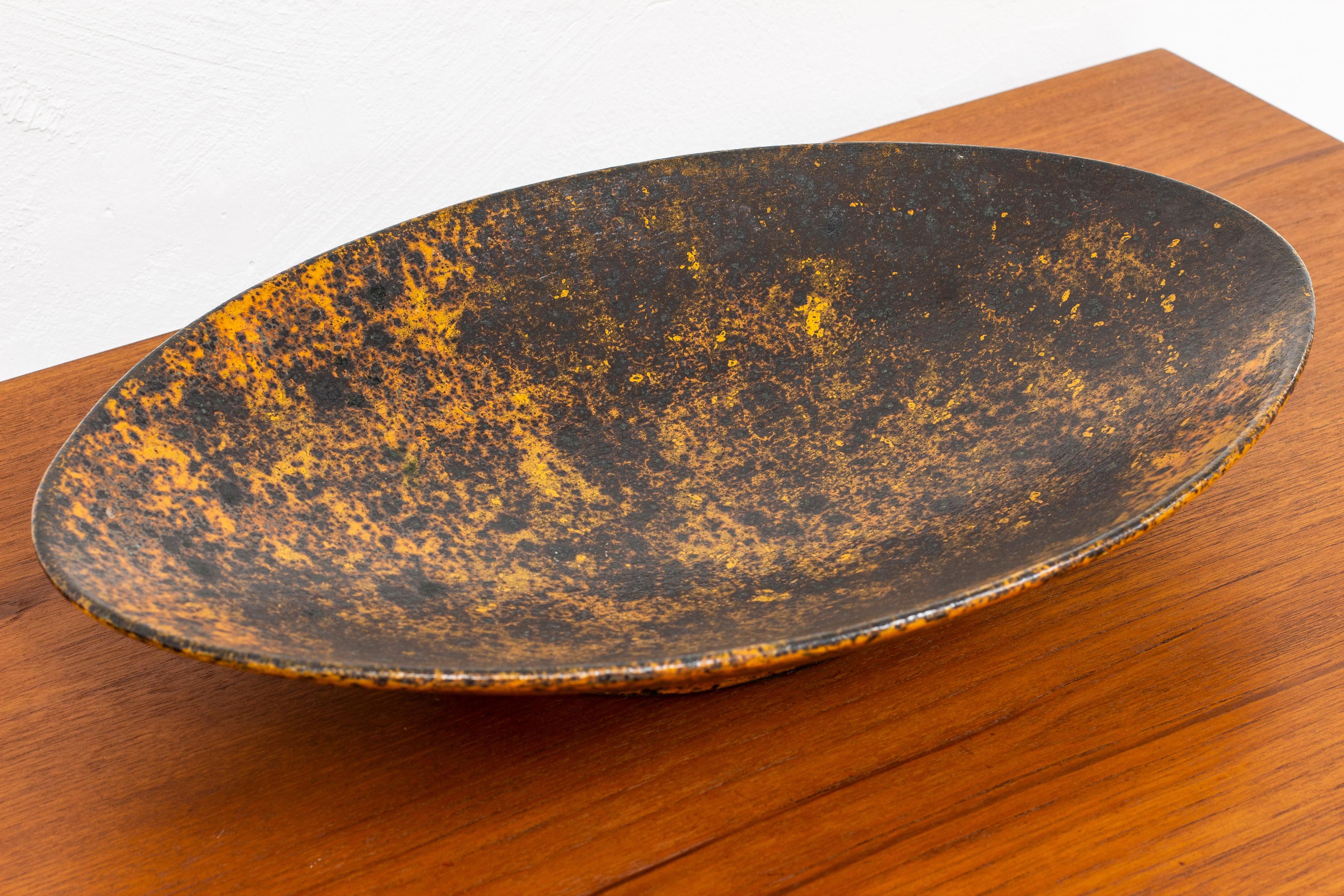 Very large dish designed and made by Hans Hedberg. Hand made in Biot France, second half of the 20th century. Made from stoneware with glaze shifting in deep blue/purple and orange. Signed underneath with his Hallmark. Very good vintage condition