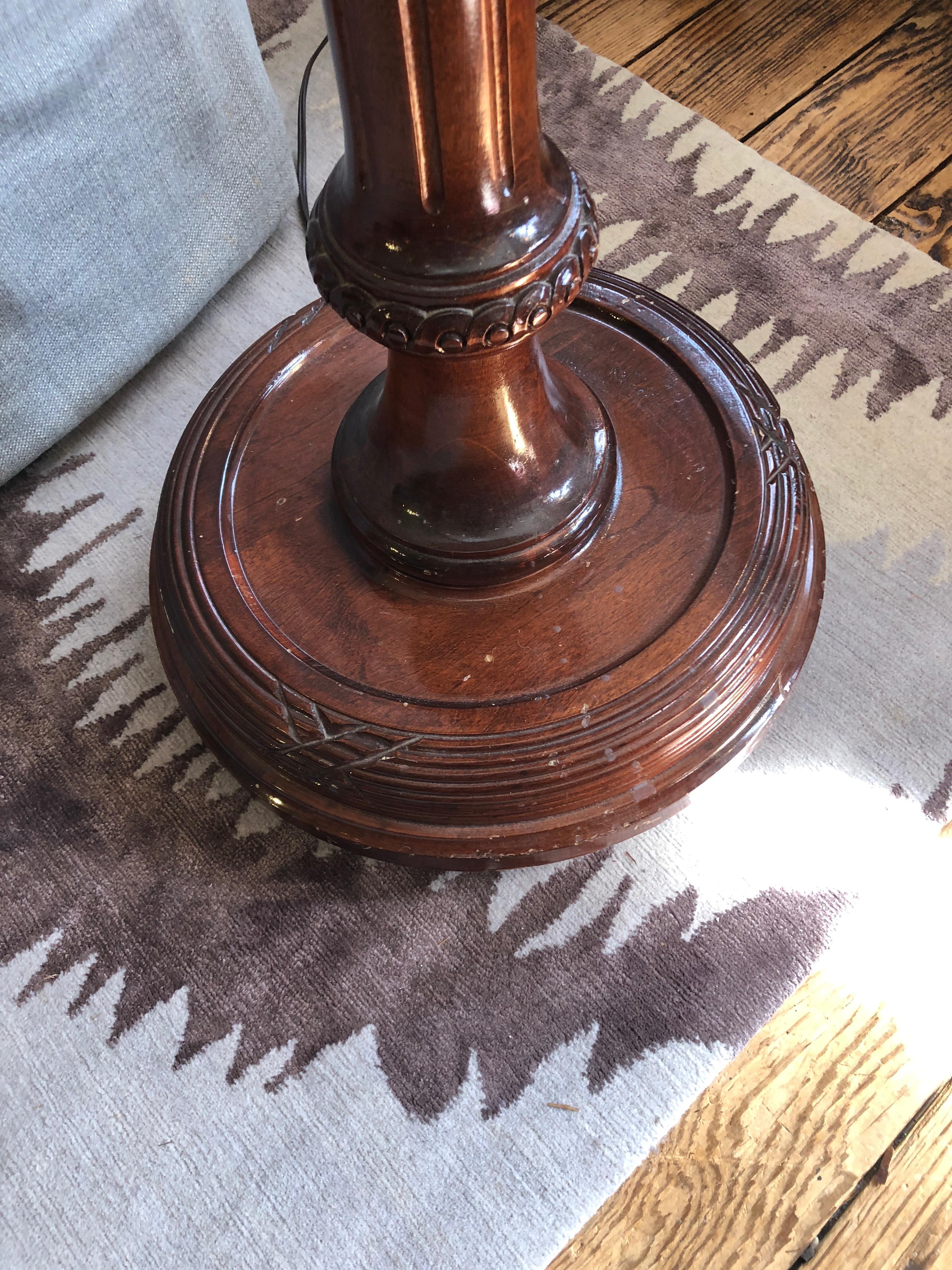 Very dramatic oversized carved wood floor lamp having a torchiere at the top on which rests an over the top theatrical sunny yellow silk shade with fringe. By Bill Blass collection.
15 inch diameter base.
NOTE:  2 are available
 