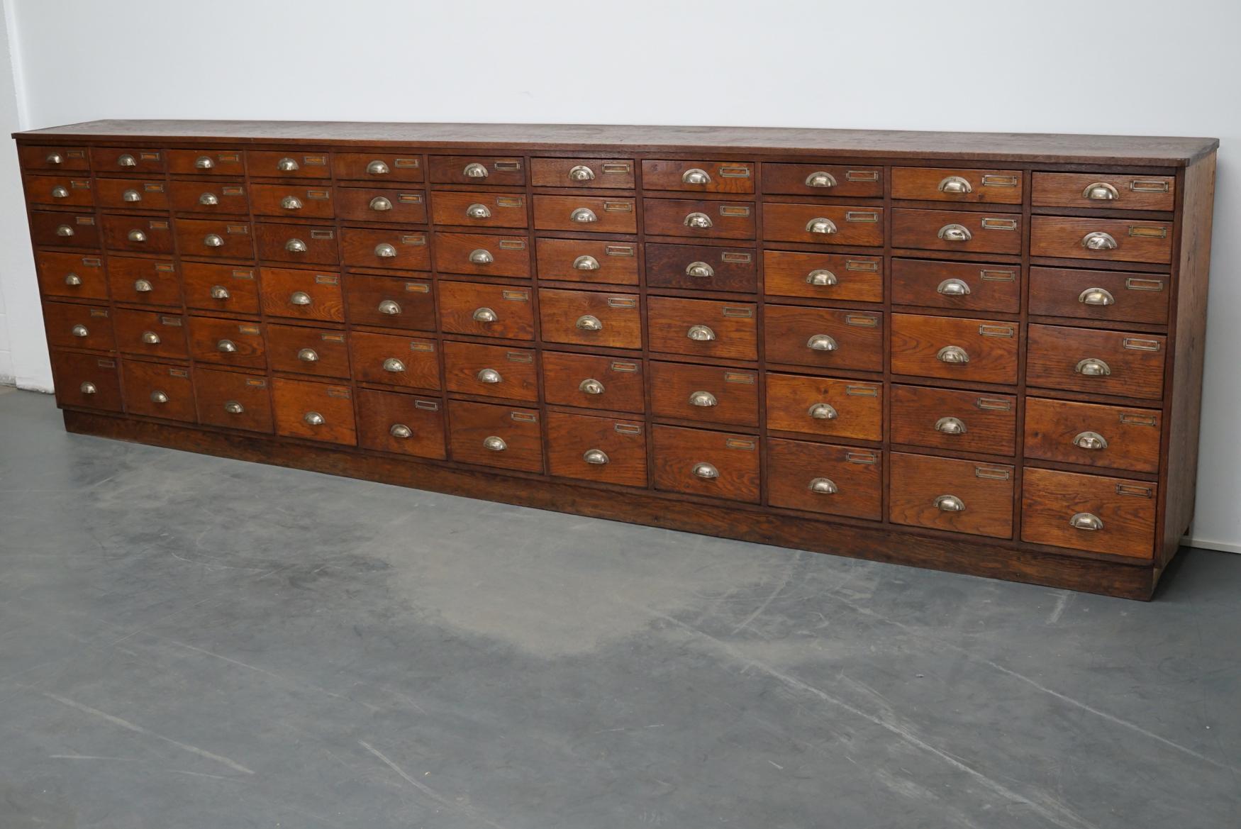 This apothecary cabinet was produced during the 1930s in the Netherlands. This piece features 66 drawers in different sizes. The interior dimensions of the drawers are: D x W x H 35 x 29 x 6 / 8 / 10 / 14 / 17 cm. The cabinet was used to store
