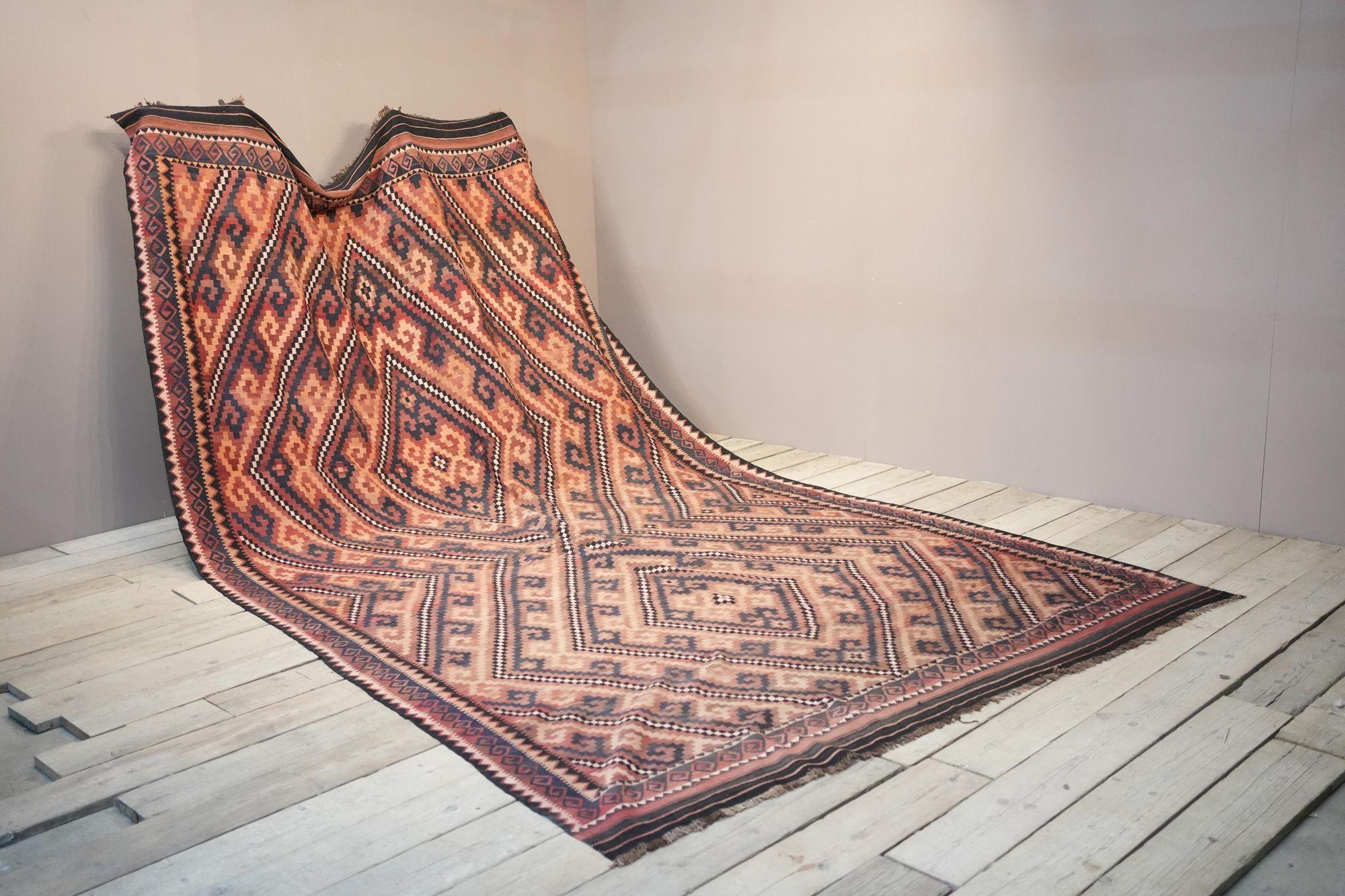 This is a fabulous very large early 20th century Maimana Kilim rug from North Afghanistan. Great quality with slightly asymmetrical design in great subtle browns and reds. Minor fading to one side but nothing that takes away from the rug and its age