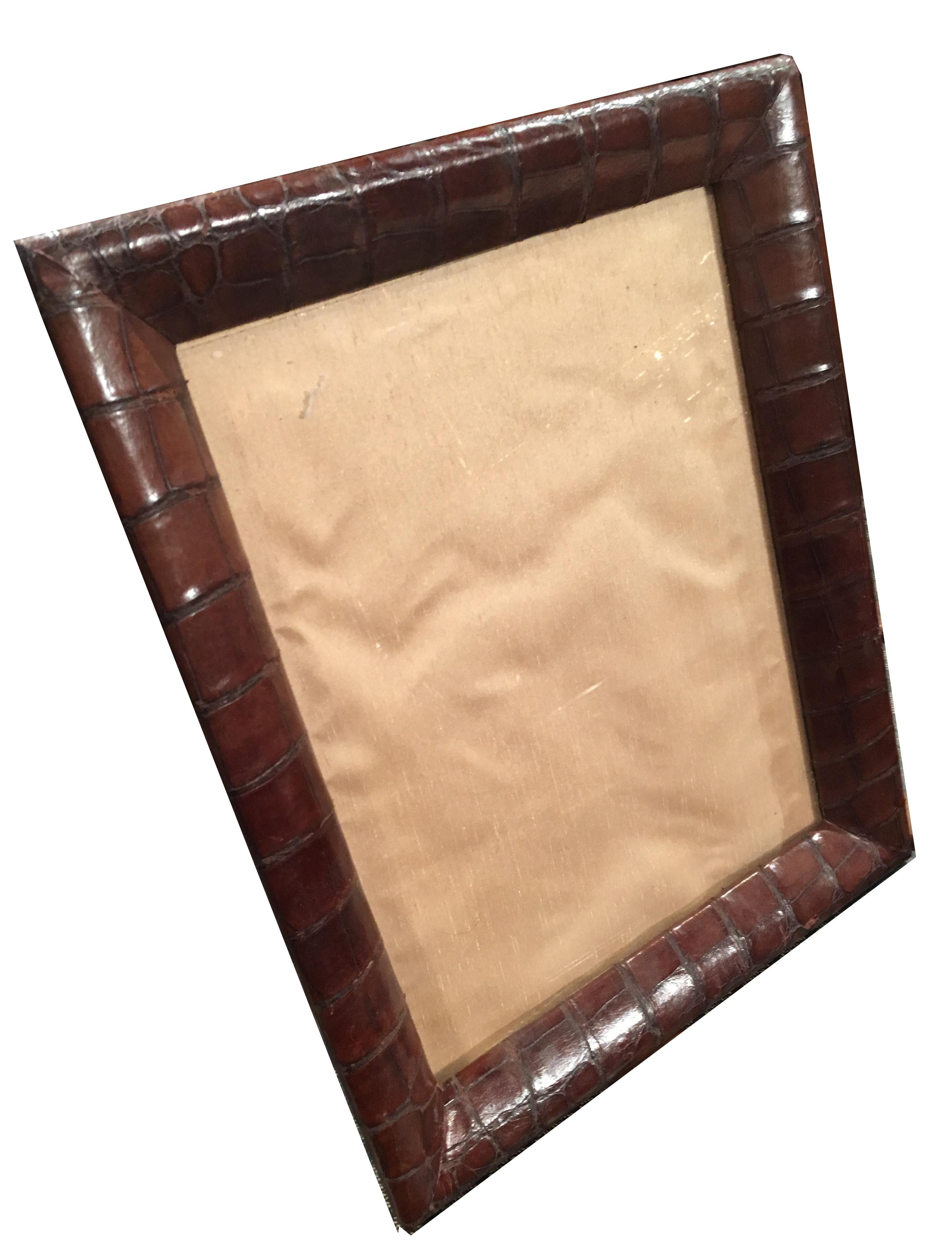 An extremely attractive Edwardian / Art Deco crocodile skin photograph frame, circa 1910-1920.

In superb condition overall. The frame has a two way leg, meaning it can be used in either portrait or landscape mode.

The crocodile edging is