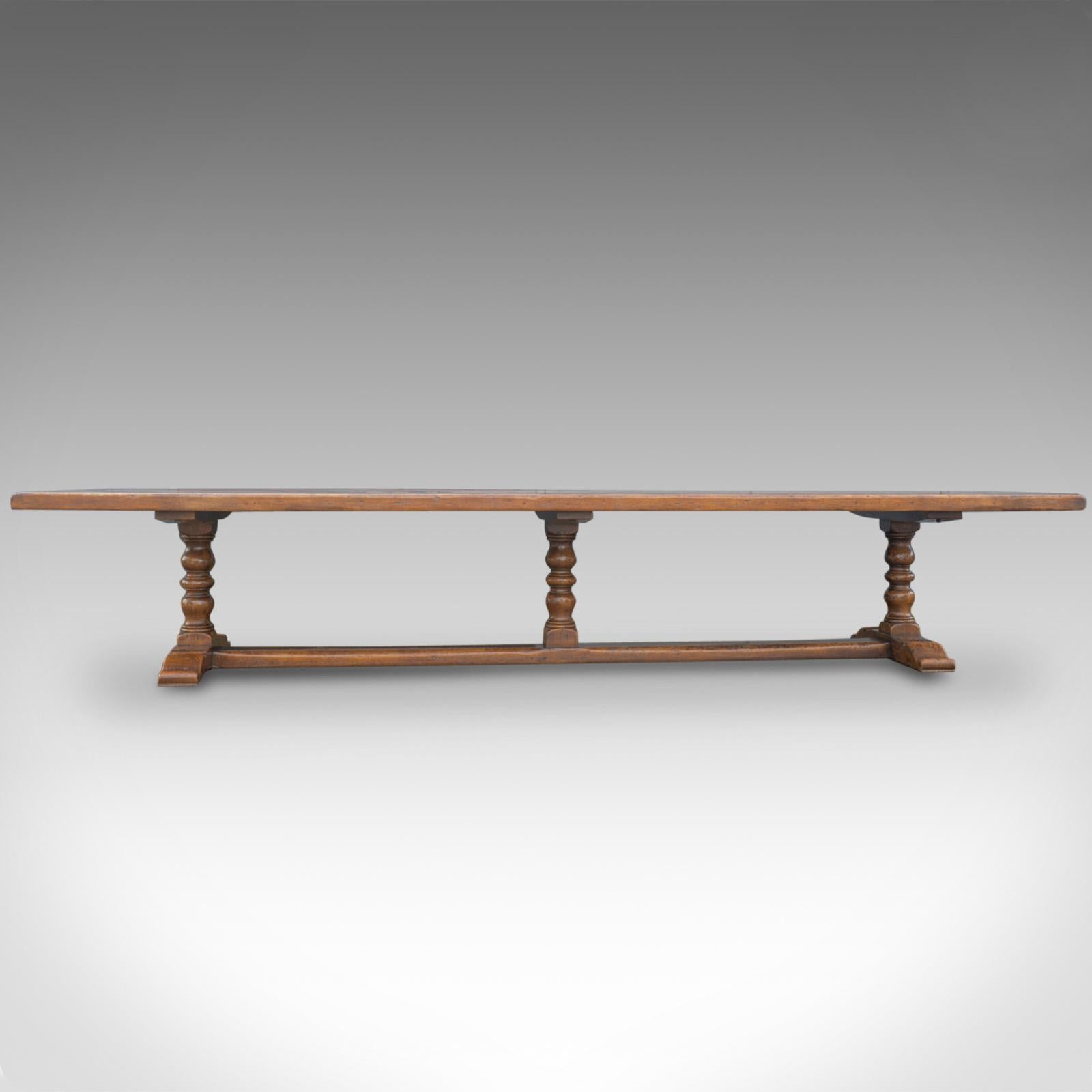 This is a very large English refectory table in the Jacobean manner, a 14 foot long, solid oak dining table seating 16-20, crafted in the late 20th century.

Of superior quality and country house proportions.
The oak displays well with a lustrous