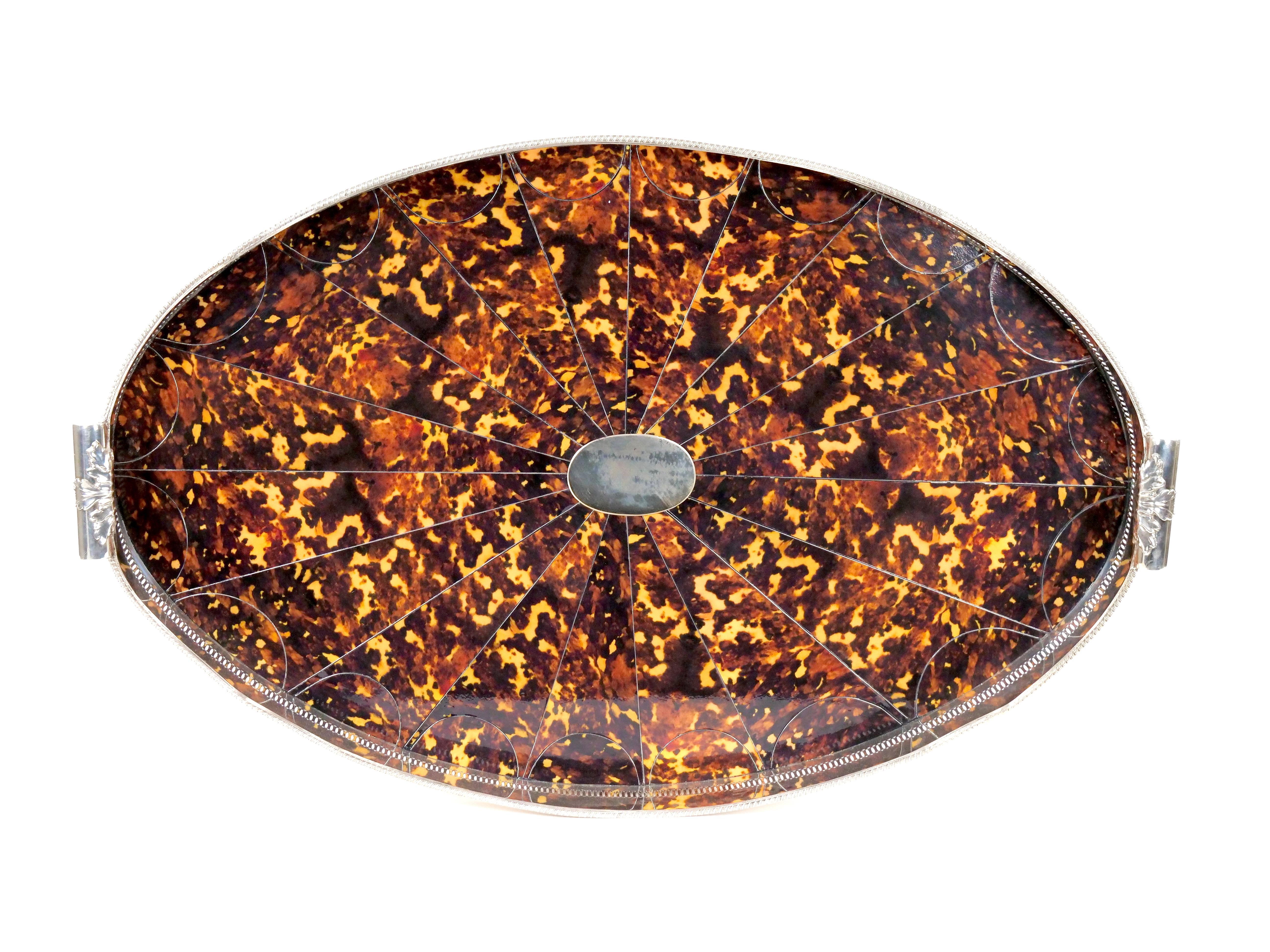Experience the grandeur of a bygone era with this exquisite Very Large English Sheffield Footed Silver Plate High Border Serving Tray, featuring a captivating Faux Tortoise Shell Inlay interior. Meticulously crafted, this tray embodies the opulence
