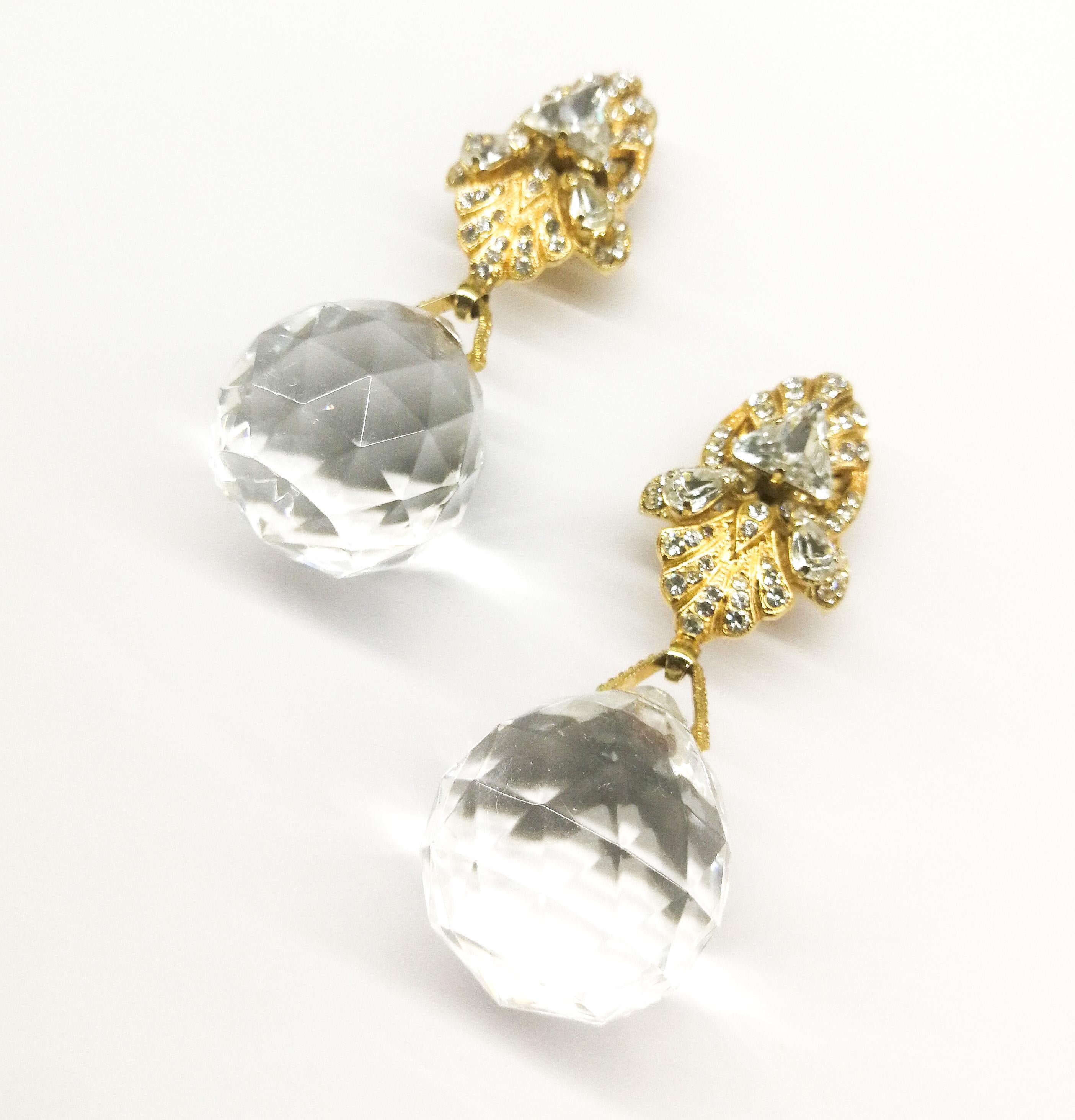 These glamorous and striking earrings are made with faceted clear resin drops, that catch and reflect the light, topped in gilt metal, set with clear pastes. If made from crystal or glass , they would be far too heavy to wear! Very typical of the