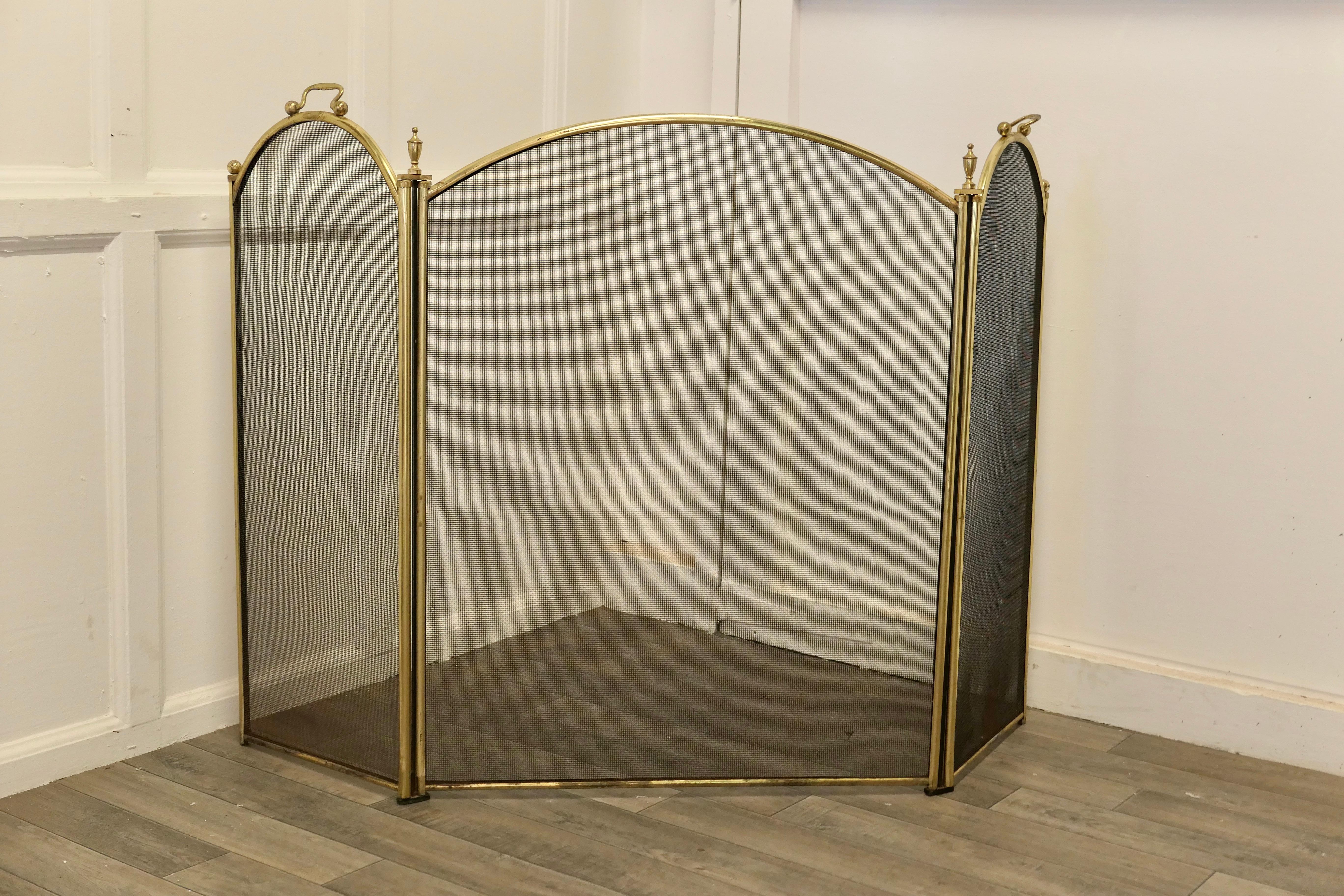 Large folding brass and iron fire guard for inglenook fireplace.

This very useful spark guard has a 3 fold brass frame and a fine black mesh infill decorated with brass finials along the top 
When opened out the screen can be shaped to enclose