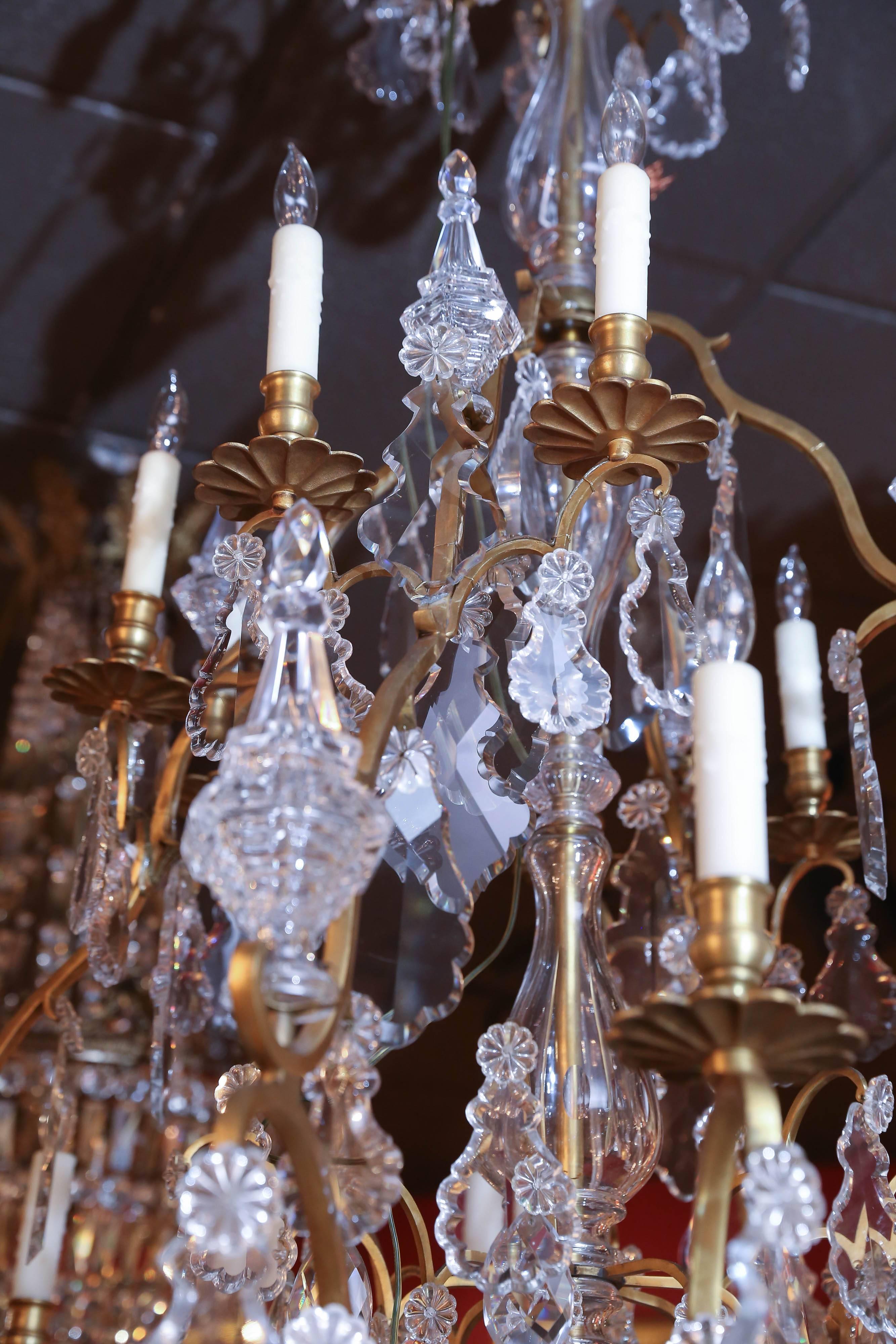 Exrtrodinary gilt bronze and crystal chandelier with a central
shaped stem issuing “S” scrollecarms, cut crystal pendants and
Finials throughout, ending in crystal globe drop
Found in Paris.