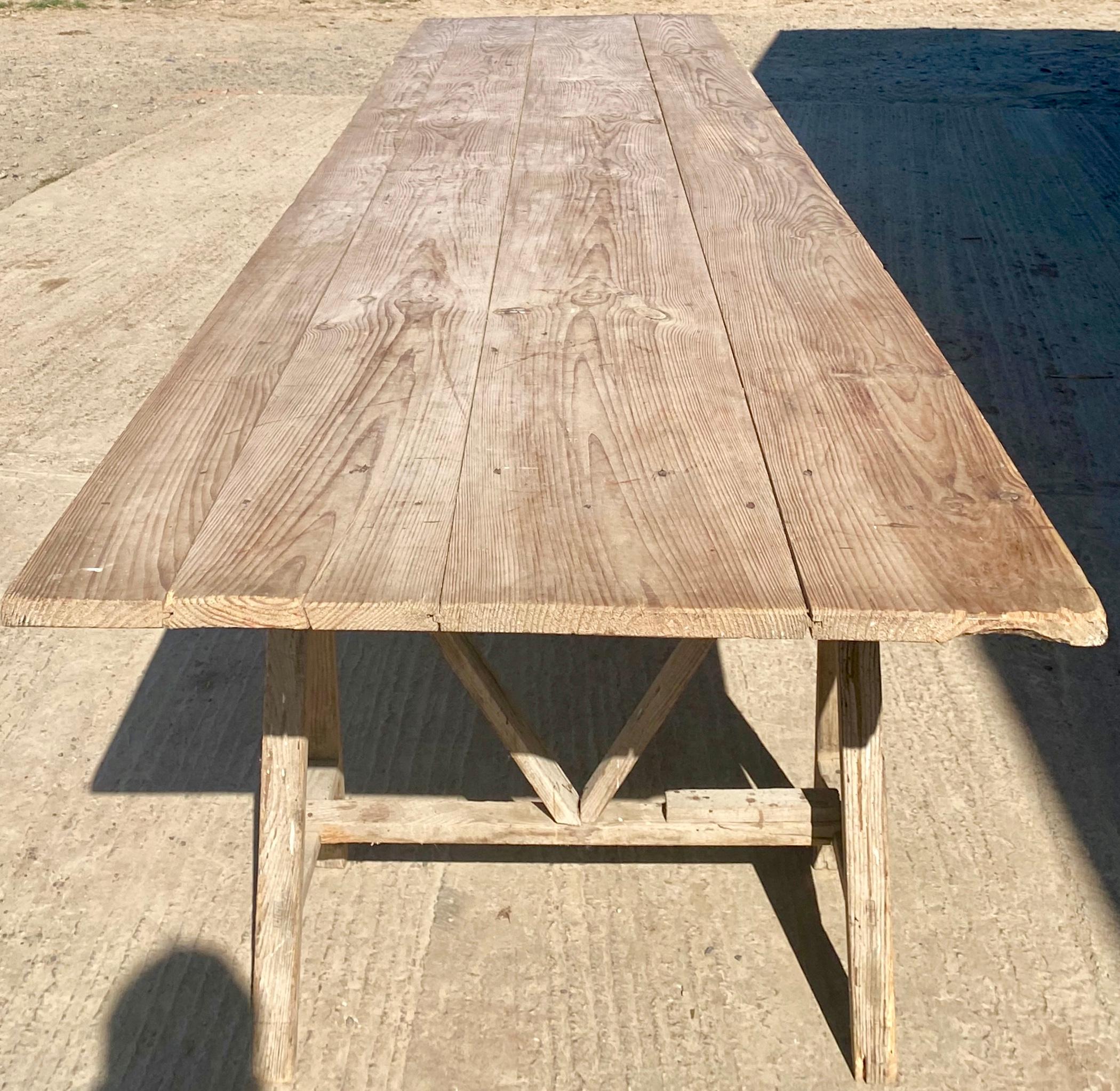 A very large 1920s French pine vendange table. Unusual in its size and width being 4 meters long and 1 meter wide. It has a lovely original patina. Very rare.
  