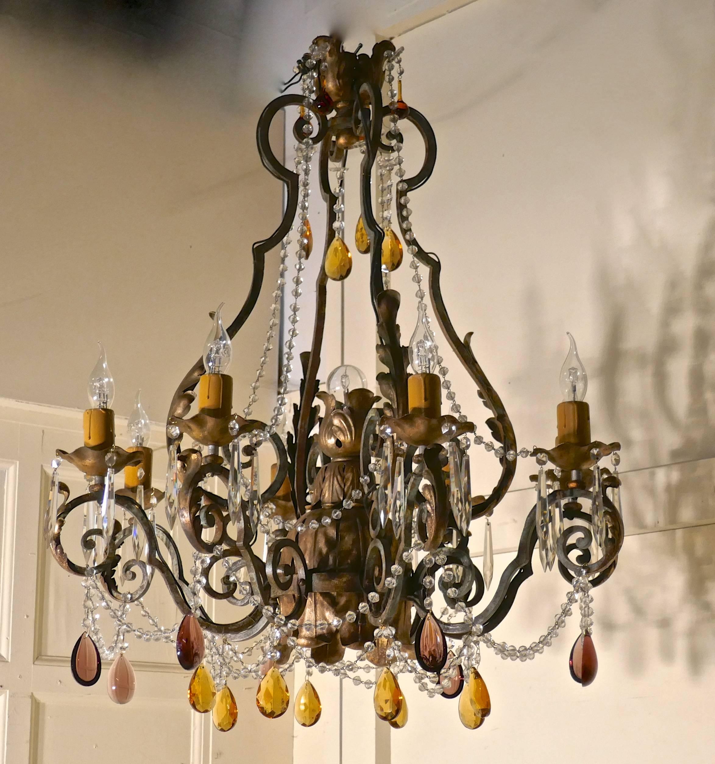 Very large French wrought iron and gilt eight branch chandelier 

This is an amazing and very heavy chandelier, the main frame of the light is in iron which has superb grey/green verdigris patina, this in turn is set with age darkened gilded brass