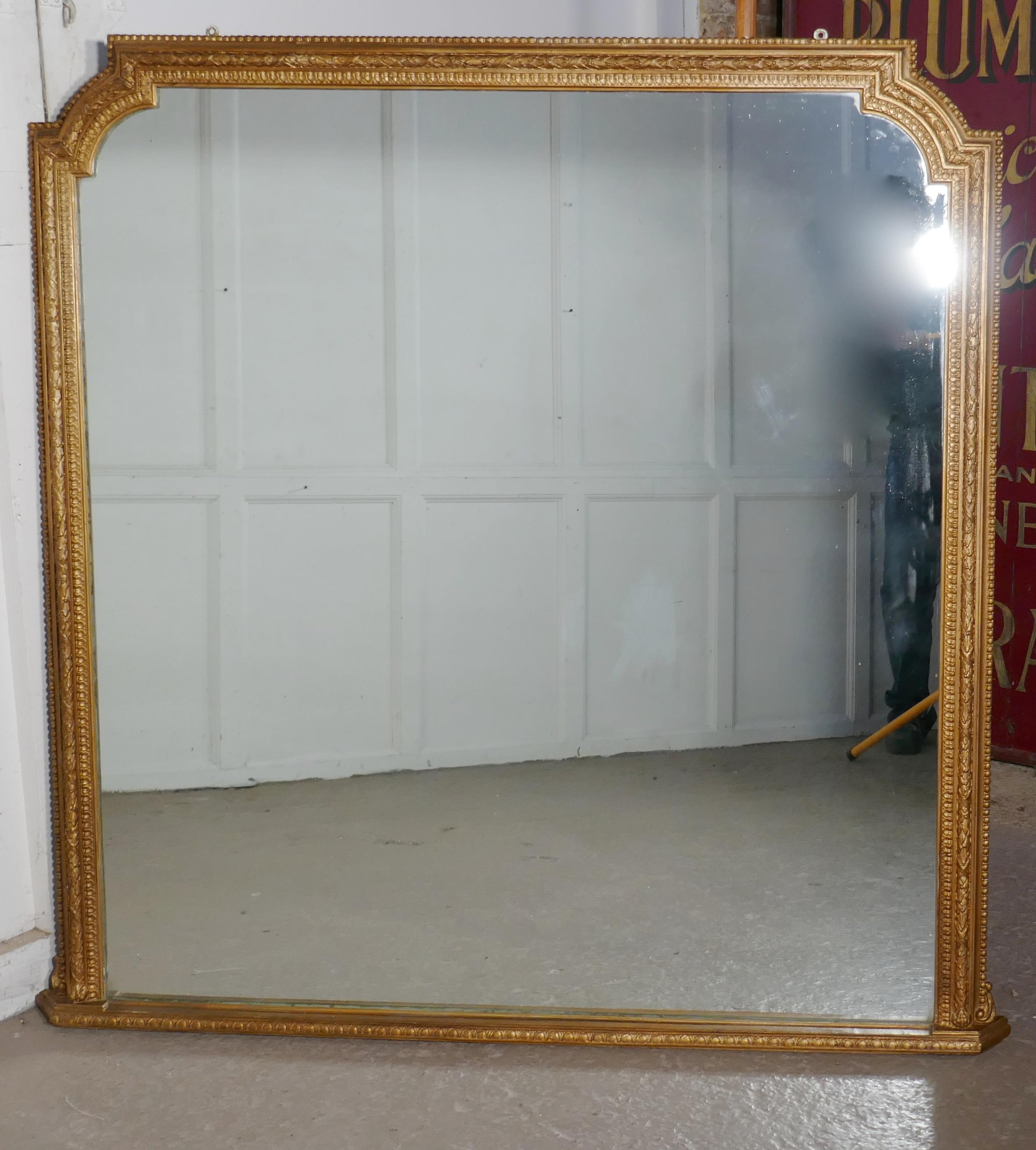 Very large gilt overmantel or over mantle mirror

The over mantel as it name implies was made to sit over the mantel piece and as so many fireplaces are opposite the window Mirrors were used to reflect more light into the room
The old gold frame