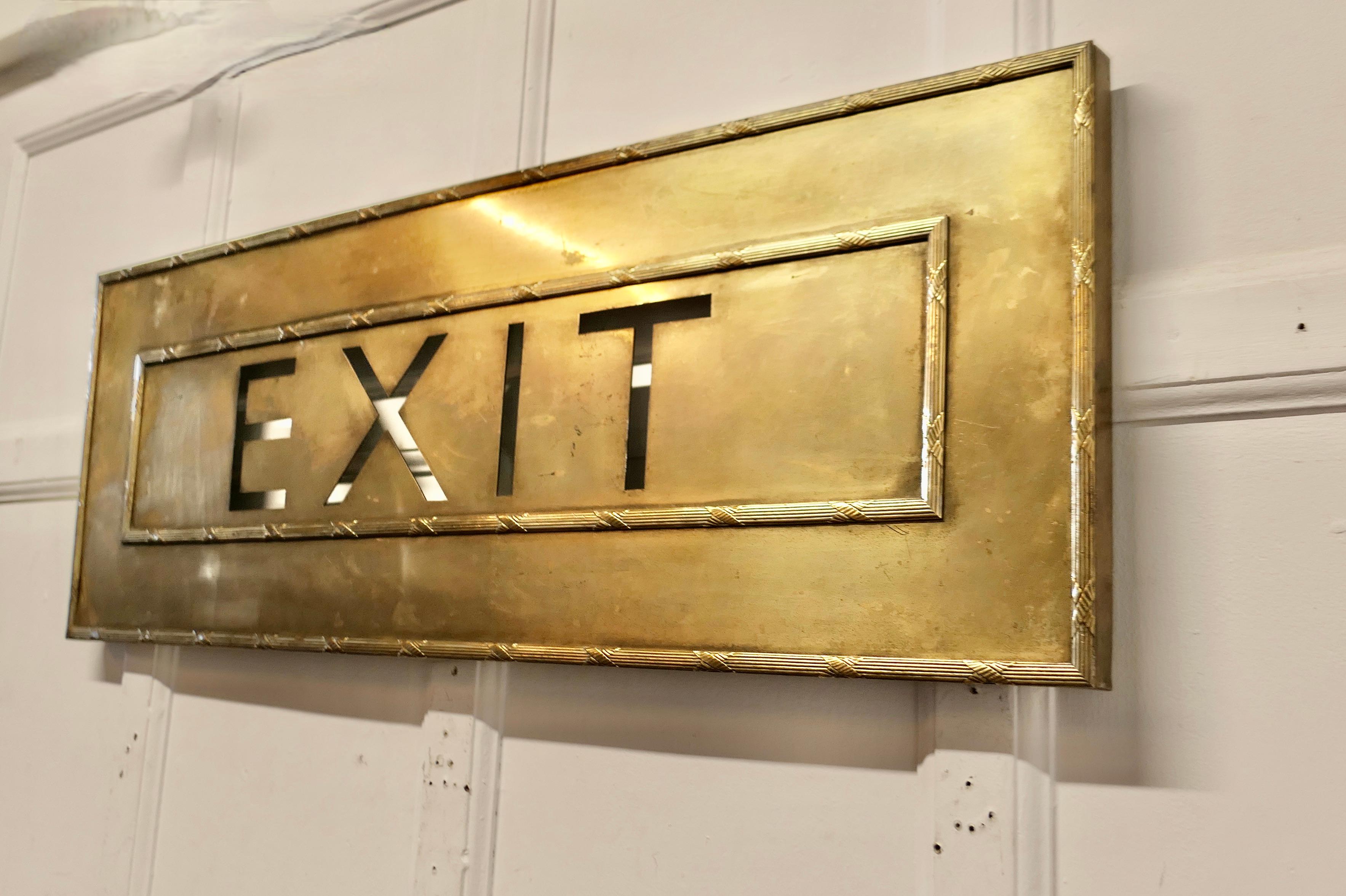 Very Large Gold Brass Odeon Cinema EXIT Sign 

A great piece of nostalgia, this is the front of a large Exit sign from a cinema, the word EXIT would have been back lit in the usual cinema style 

In gilt metal the light has typical Odeon a