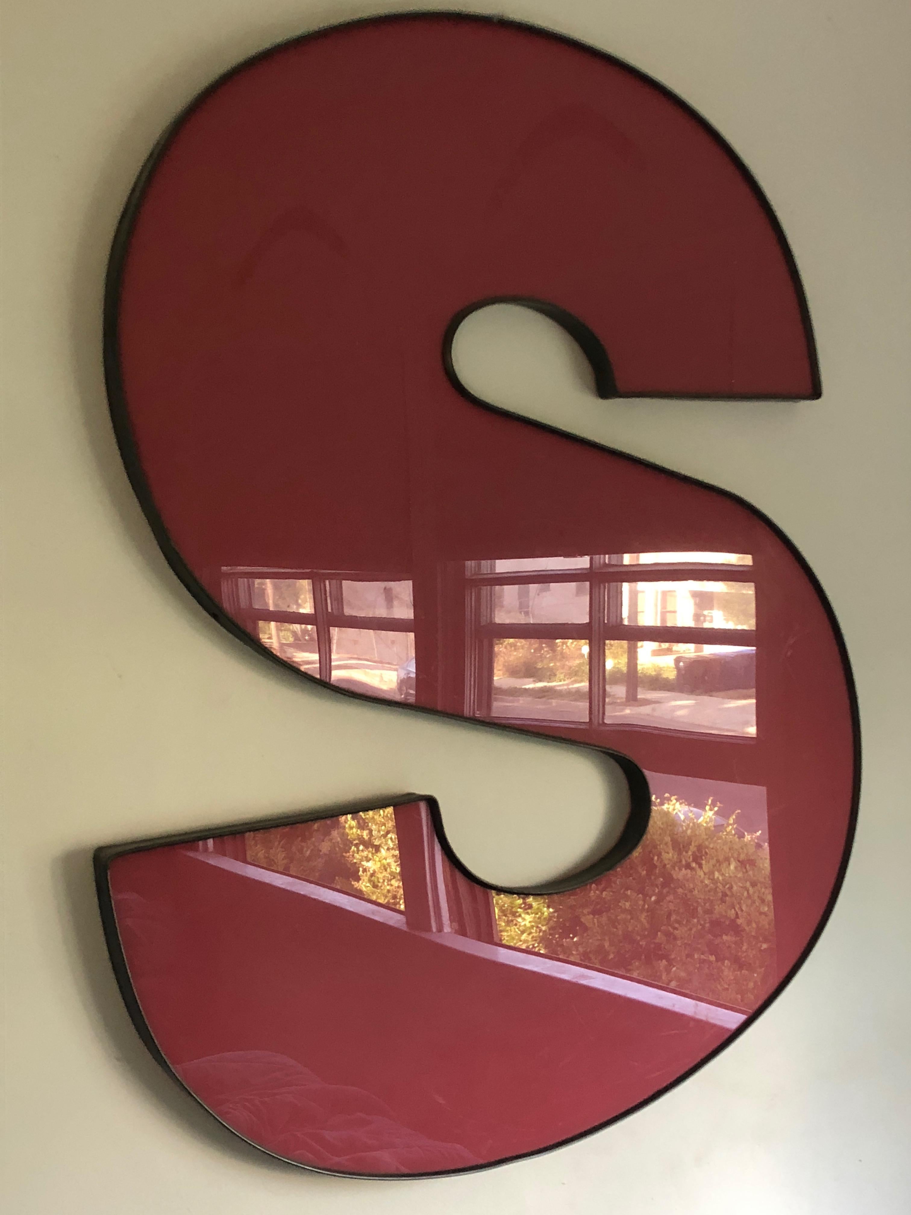 A bold red acrylic letter 