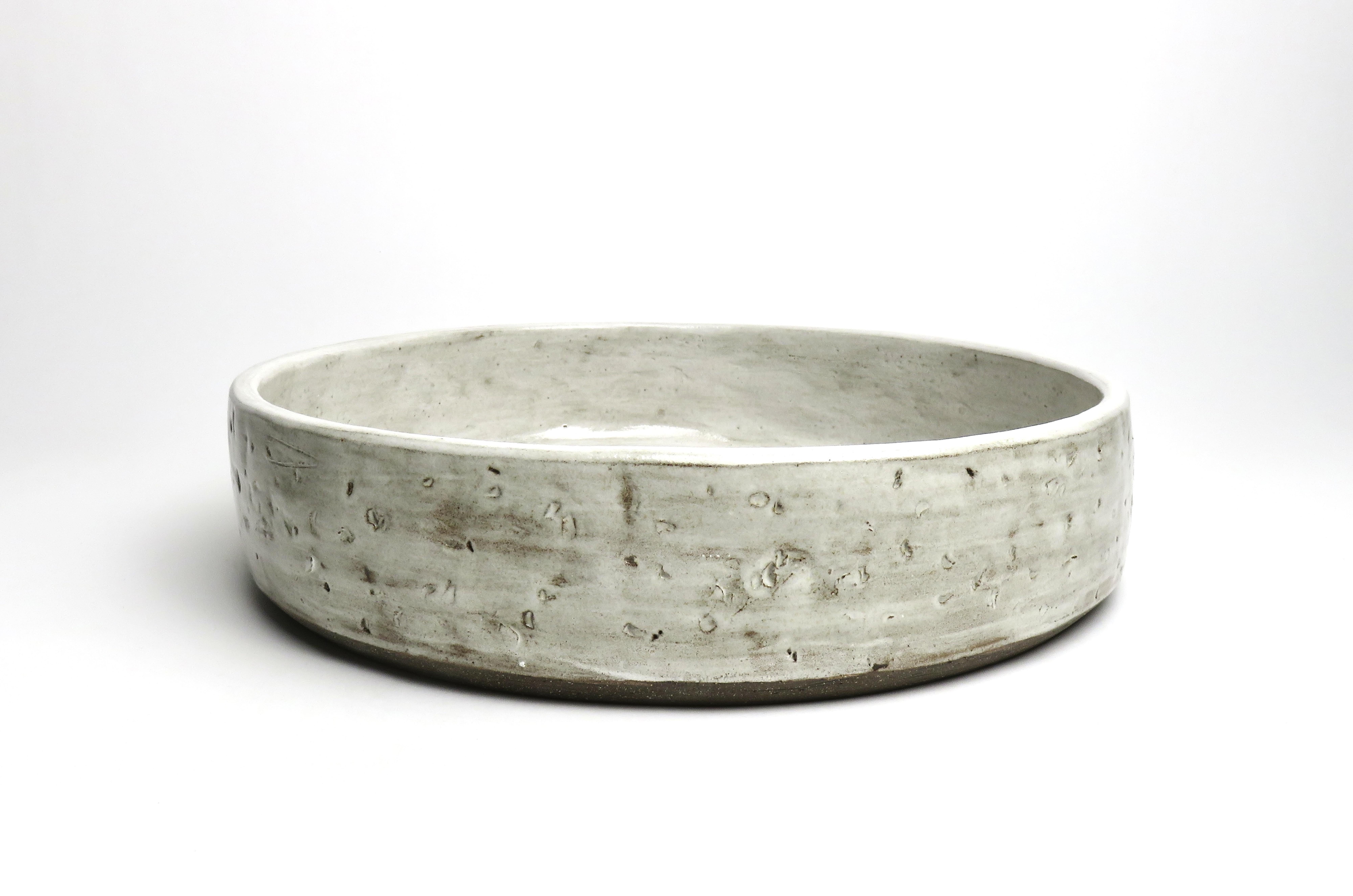 Rustic yet elegant, hand built ceramic serving bowl.  Its handmade quality and sculptural reference makes it a beautiful piece for the table at all times.  At over 12 inches in diameter it makes a strong statement, not to be mistaken with something