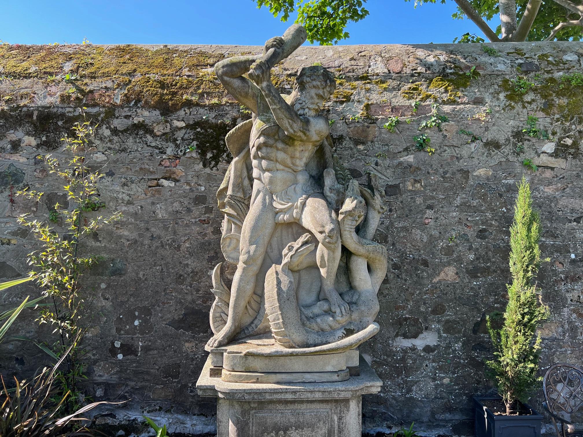 A large and impressive hand-carved Italian Vicenza stone statue on its original raised plinth
Depicting ‘Hercules defeats the Hydra’.

From a country house in Manchester where it stood for over 50 years, its aged very well, with a lovely patina, and