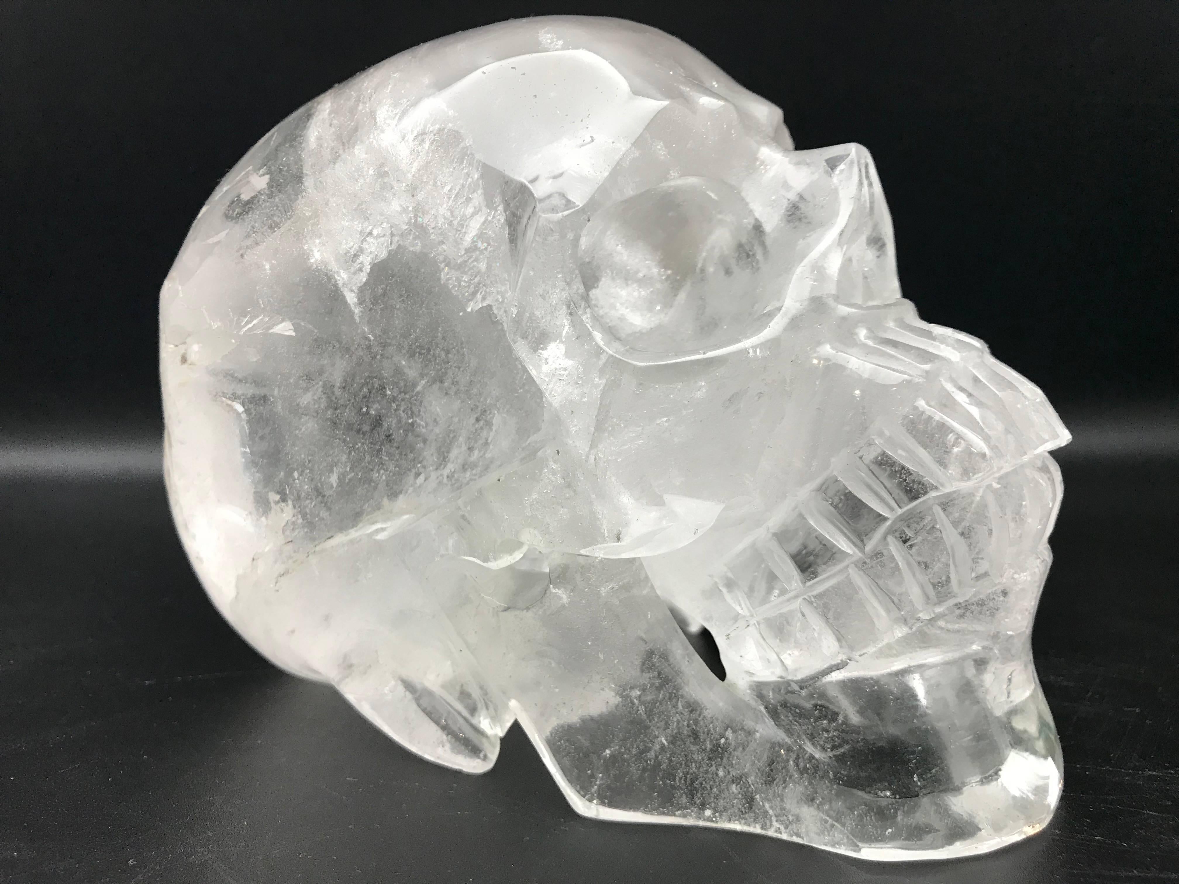 This very large rock crystal skull was hand-carved in Brazil. Rock crystal, a form of quartz, has been used in jewelry and ornaments since antiquity, and is the purest possible form of quartz.
