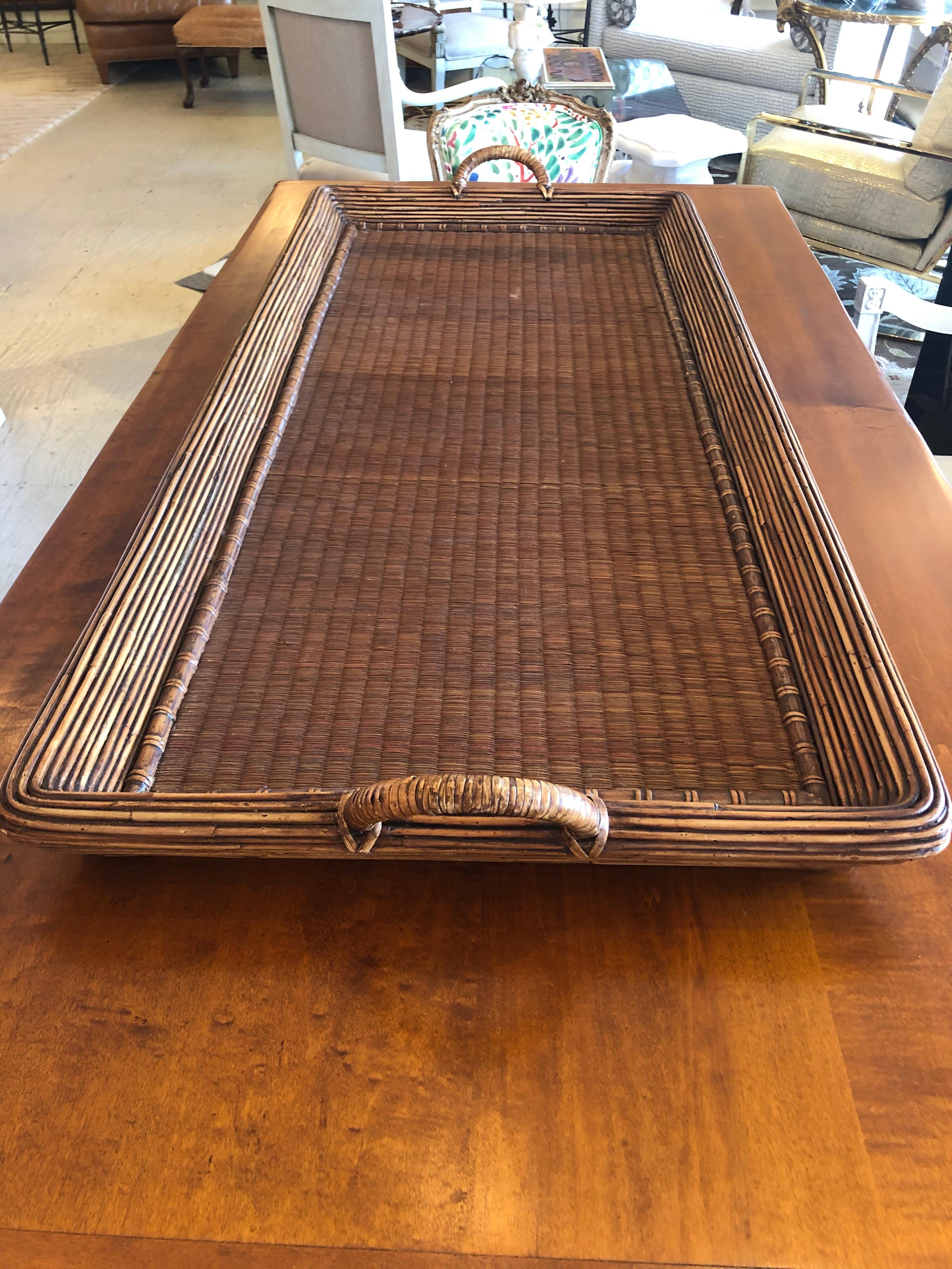A super sized handsome handled gallery tray, that's a humungous rectangle made of wicker, rattan, wood and seagrass. Would be fabulous on a large ottoman or farm table.
 