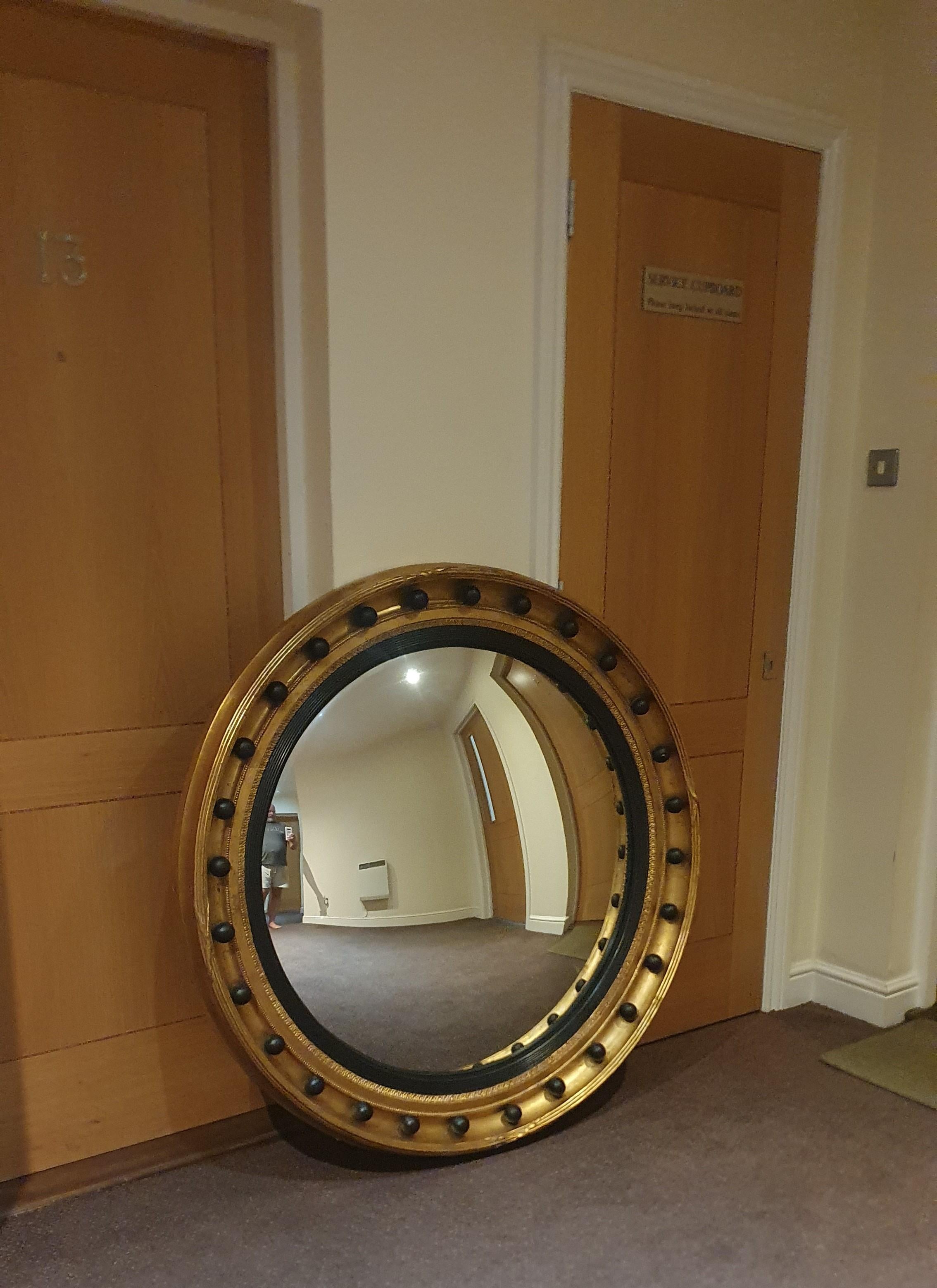 British Very large heavily carved Regency style round Gilt frame with Convex Mirror For Sale