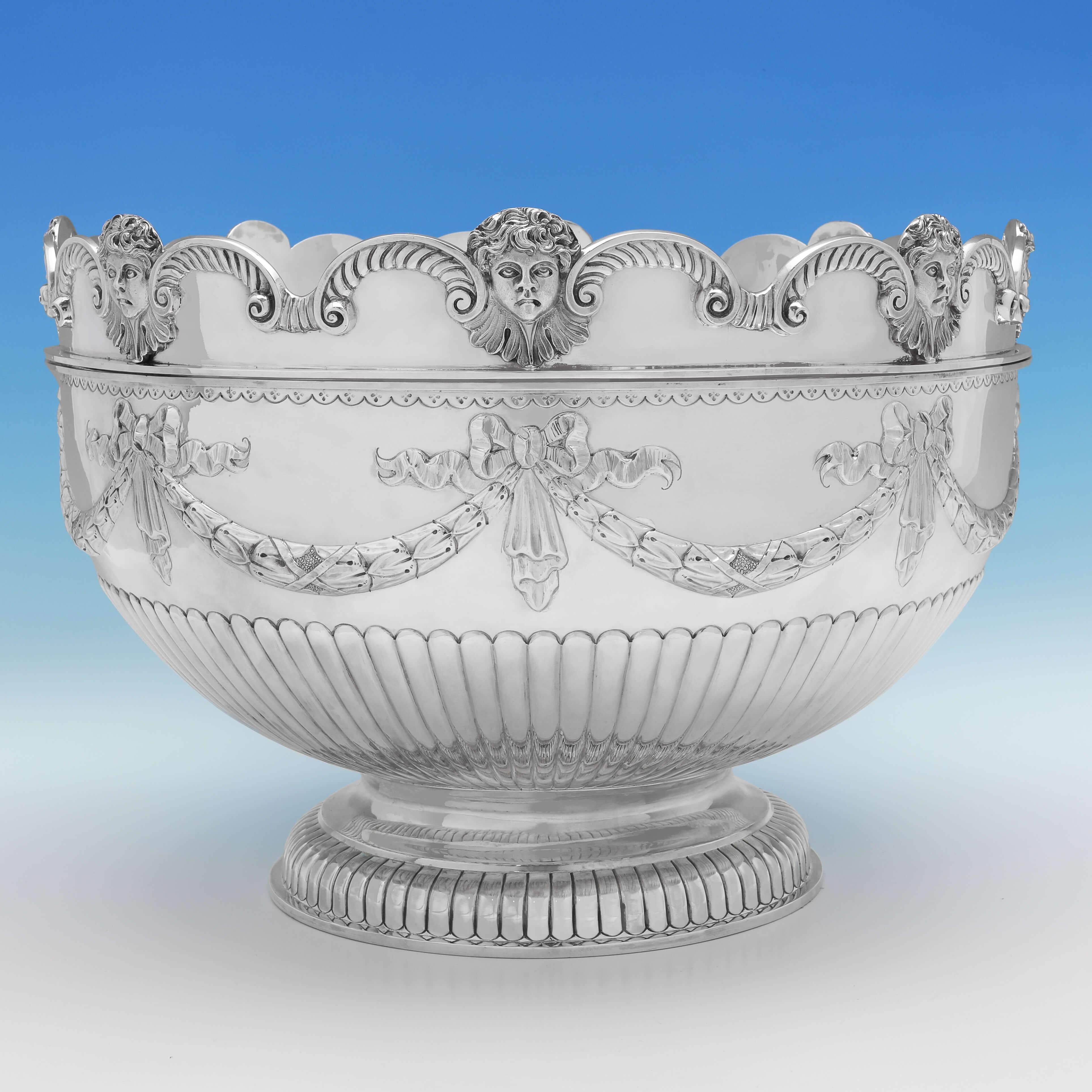 Hallmarked in London in 1880 by Aldwinckle & Slater, this attractive, very large, Victorian, antique sterling silver bowl, is in the 'Monteith' style, featuring a removable rim, and a gilt interior to the bowl. The bowl measures 11.25