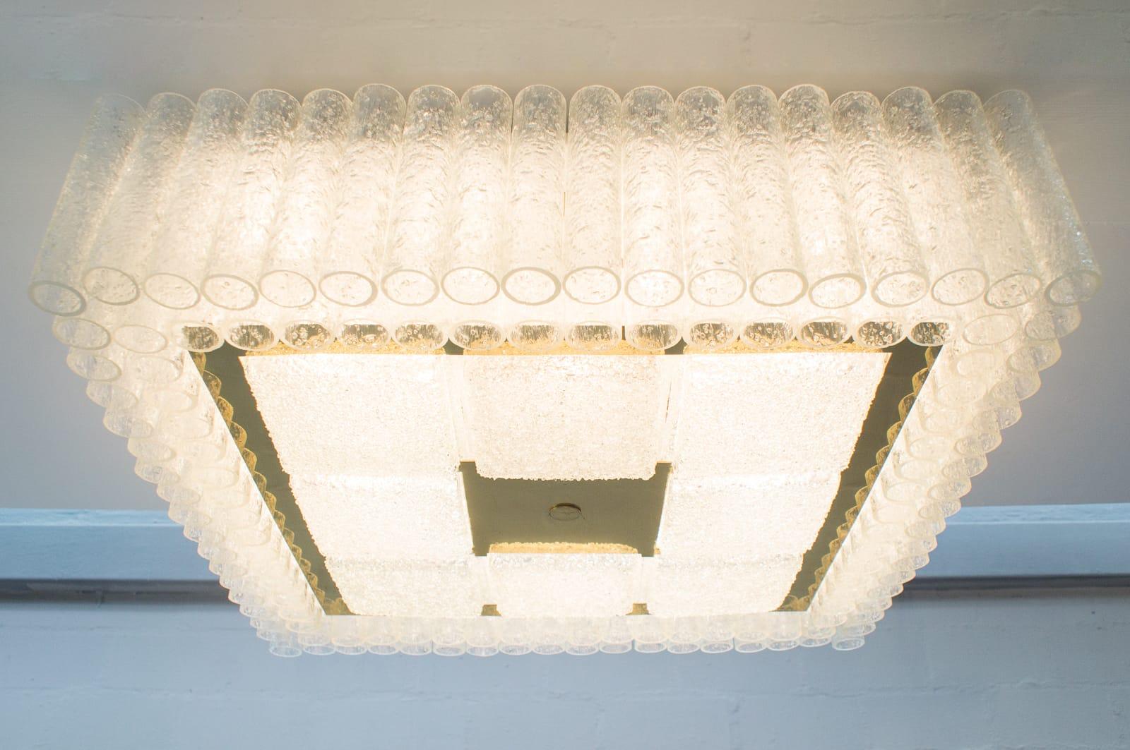 Large ceiling lamp from Doria Leuchten.
Total of 132 glass tubes and 8 square glass pieces.
Requires 16 E27 bulbs.
     