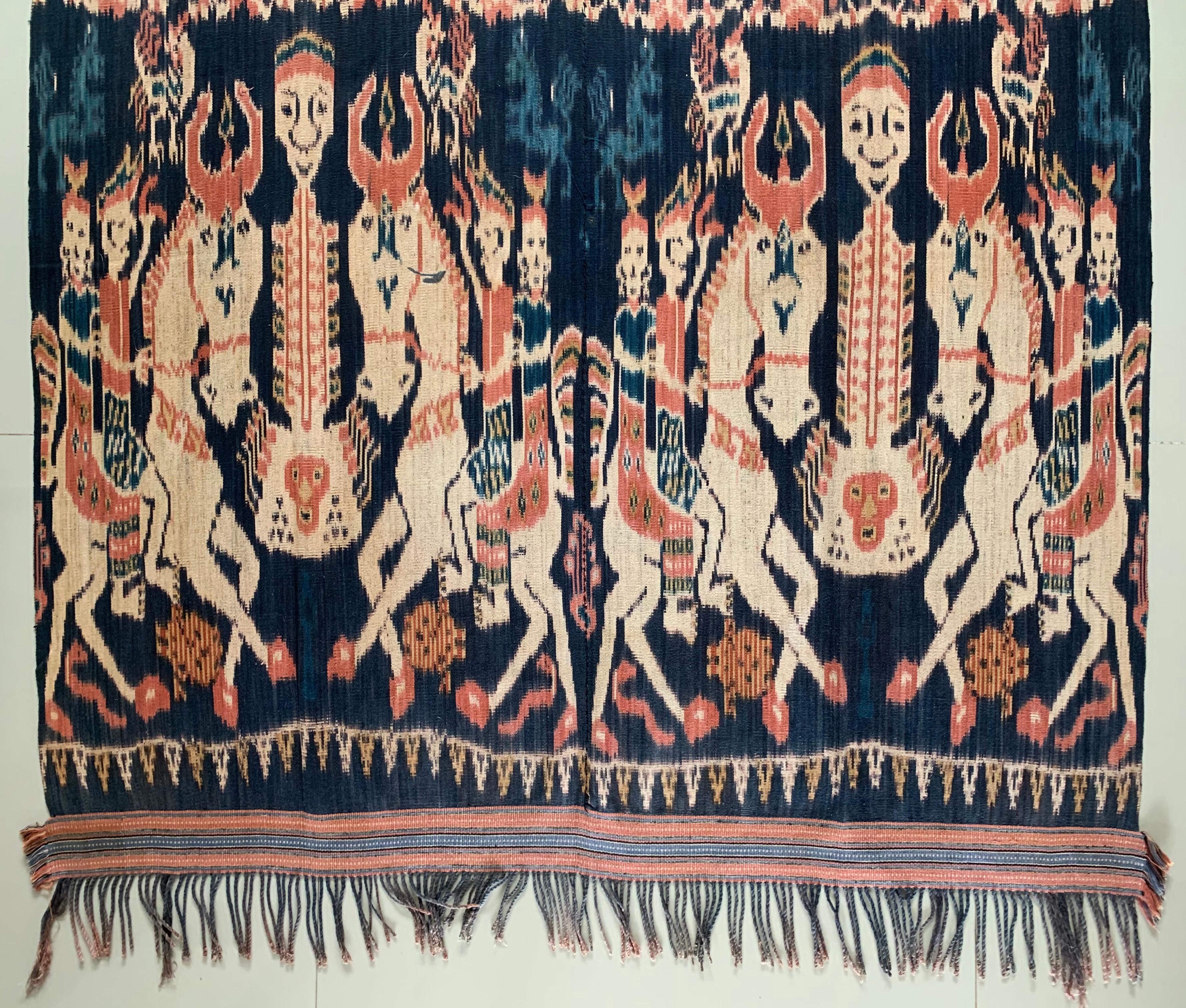 This Ikat textile originates from the Island of Sumba, Indonesia. It is hand-woven using naturally dyed yarns via a method passed on through generations. It features a stunning array of distinct tribal patterns and chicken, horse and human motifs. A