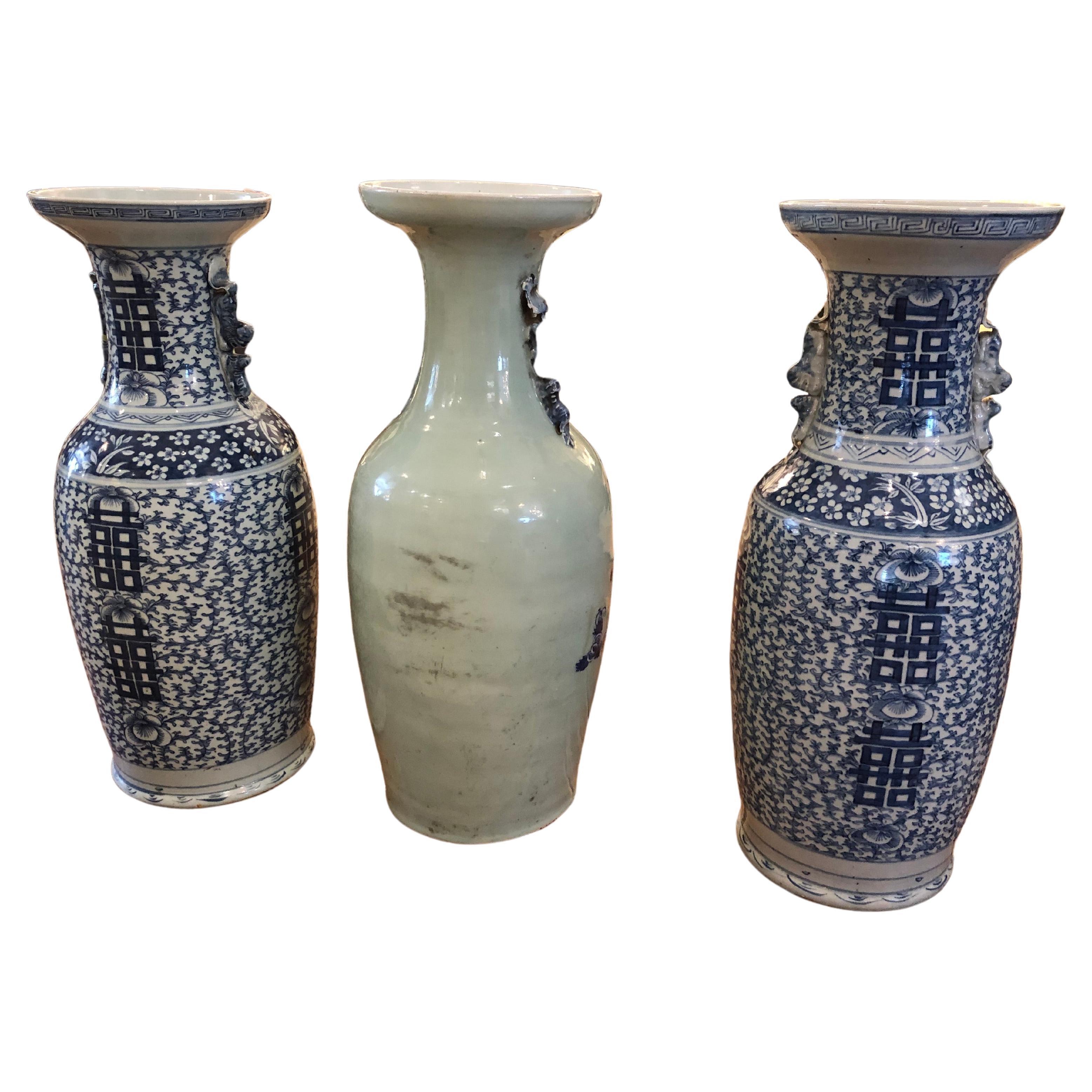 An antique collection of 3 very large blue and white Chinese vases, two are a pair but not exactly alike. Beautiful decoration and side handles. The pair are slightly shorter and smaller than the single vase measuring 23.5 h 8 diameter at the top,