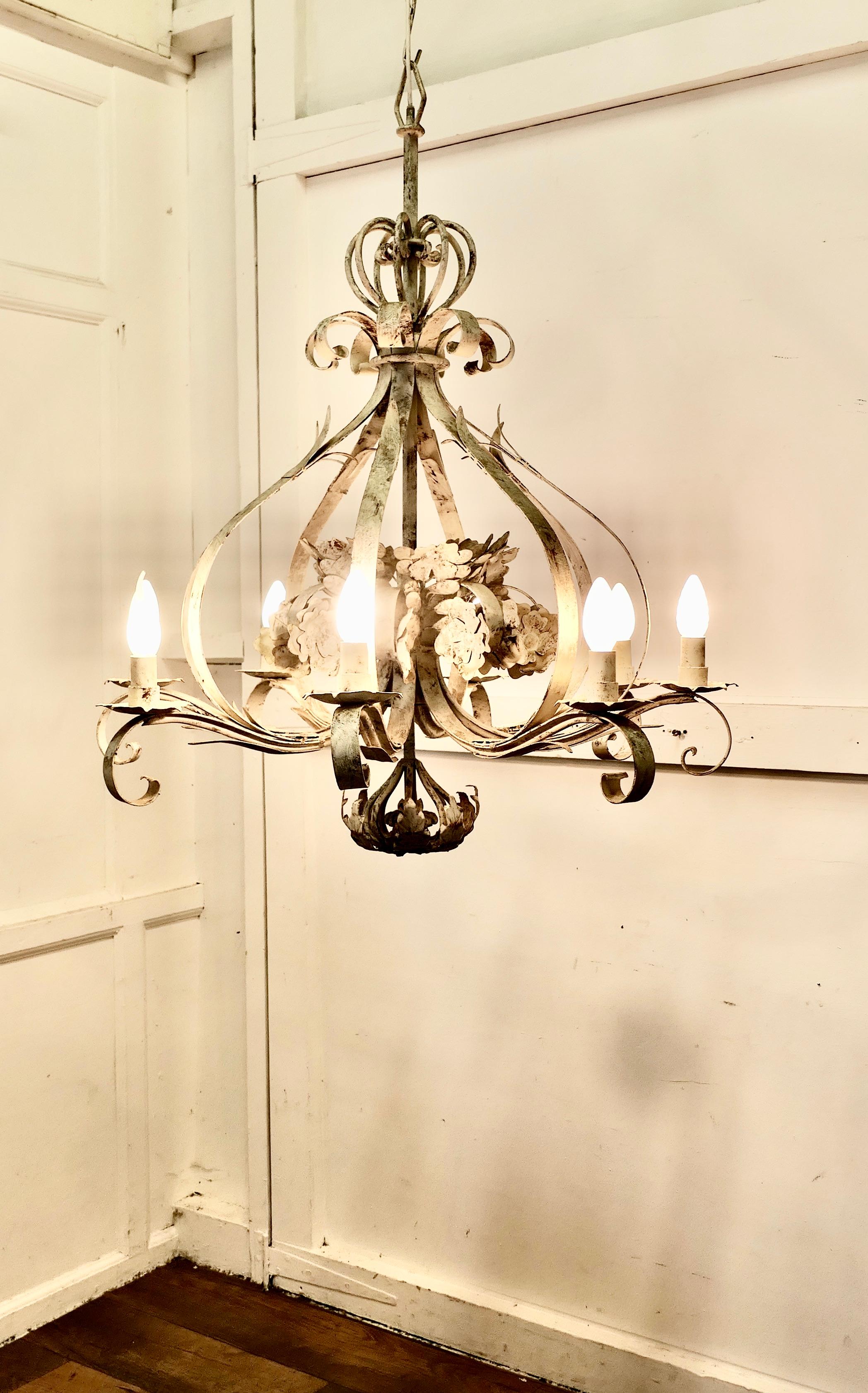 Very Large Italian 8 Branch Open Ceiling Chandelier, Distressed White

This is a a very large ceiling light, the light is open in the centre and decorated with flowers and leaves
A very dramatic light on a long chain and a great look, amazing when