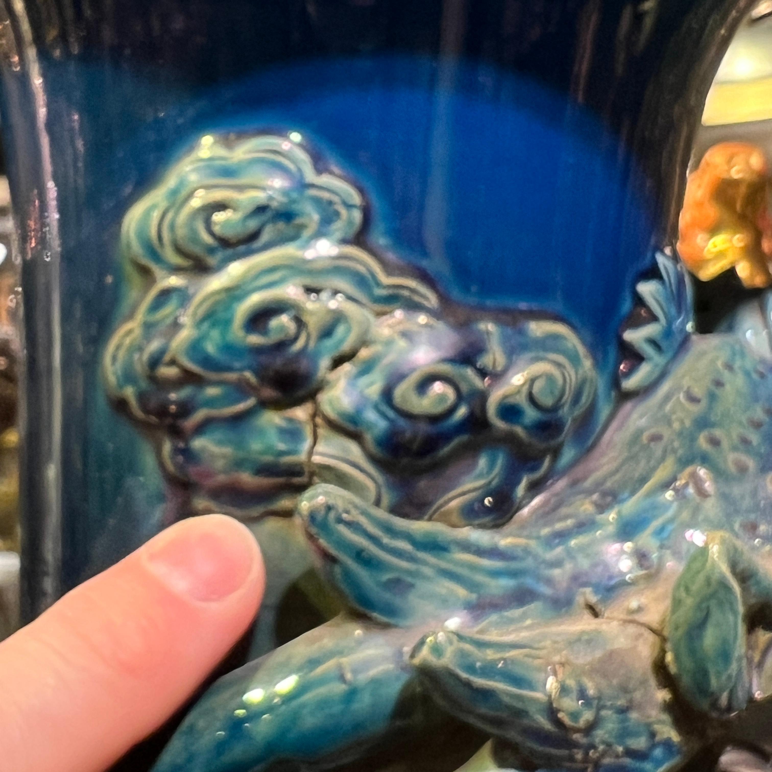 Very tall Japanese  ceramic vase with blue flambe glaze and the winding figure of a dragon.  With wooden stand.  Vase alone 30 1/2 inches tall.  Stand 6 3/4 inches tall.  Apparently unsigned.