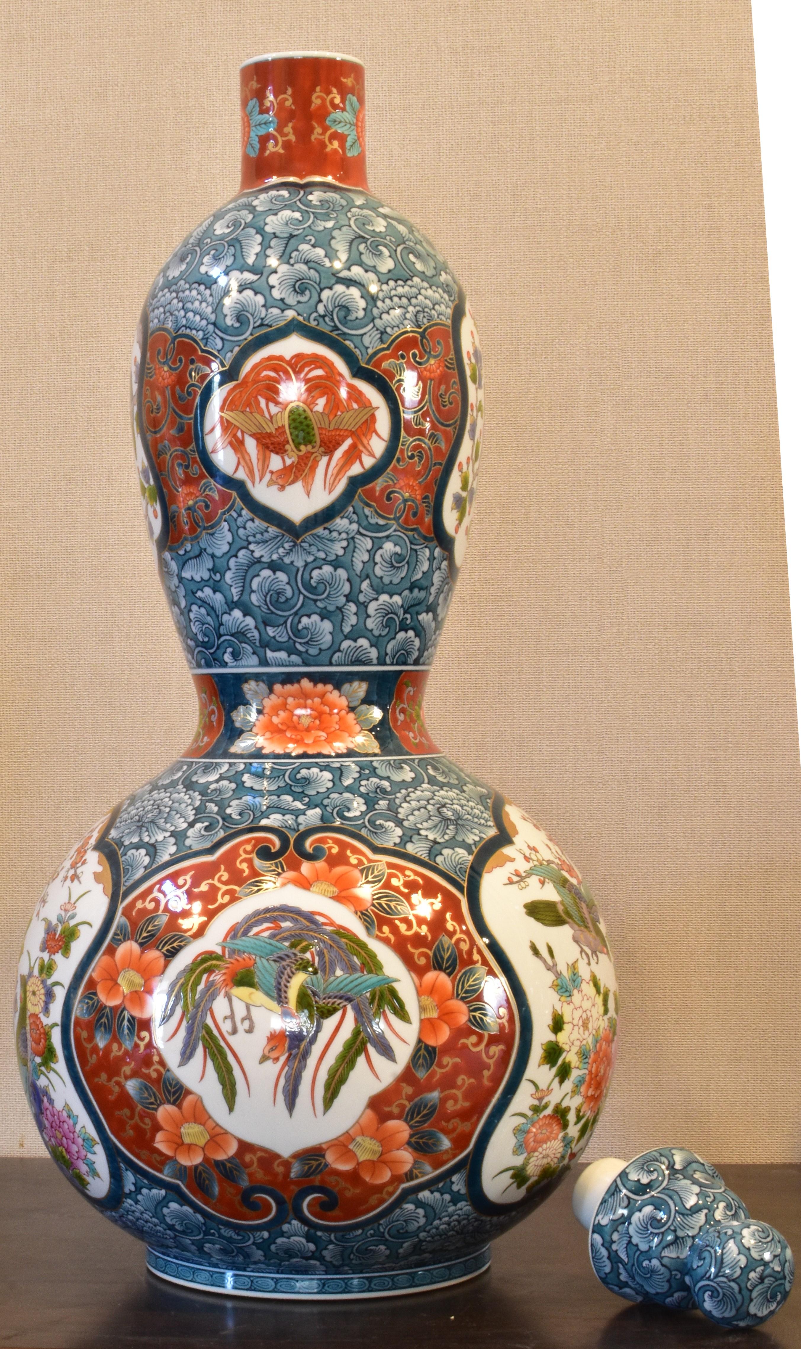 Very large unique exceptional contemporary Japanese lidded ceramic vase, intricately hand painted in blue underglaze and polychrome overglaze enameling in red and blue, on a stunning double gourd body, a signed masterpiece by highly acclaimed and
