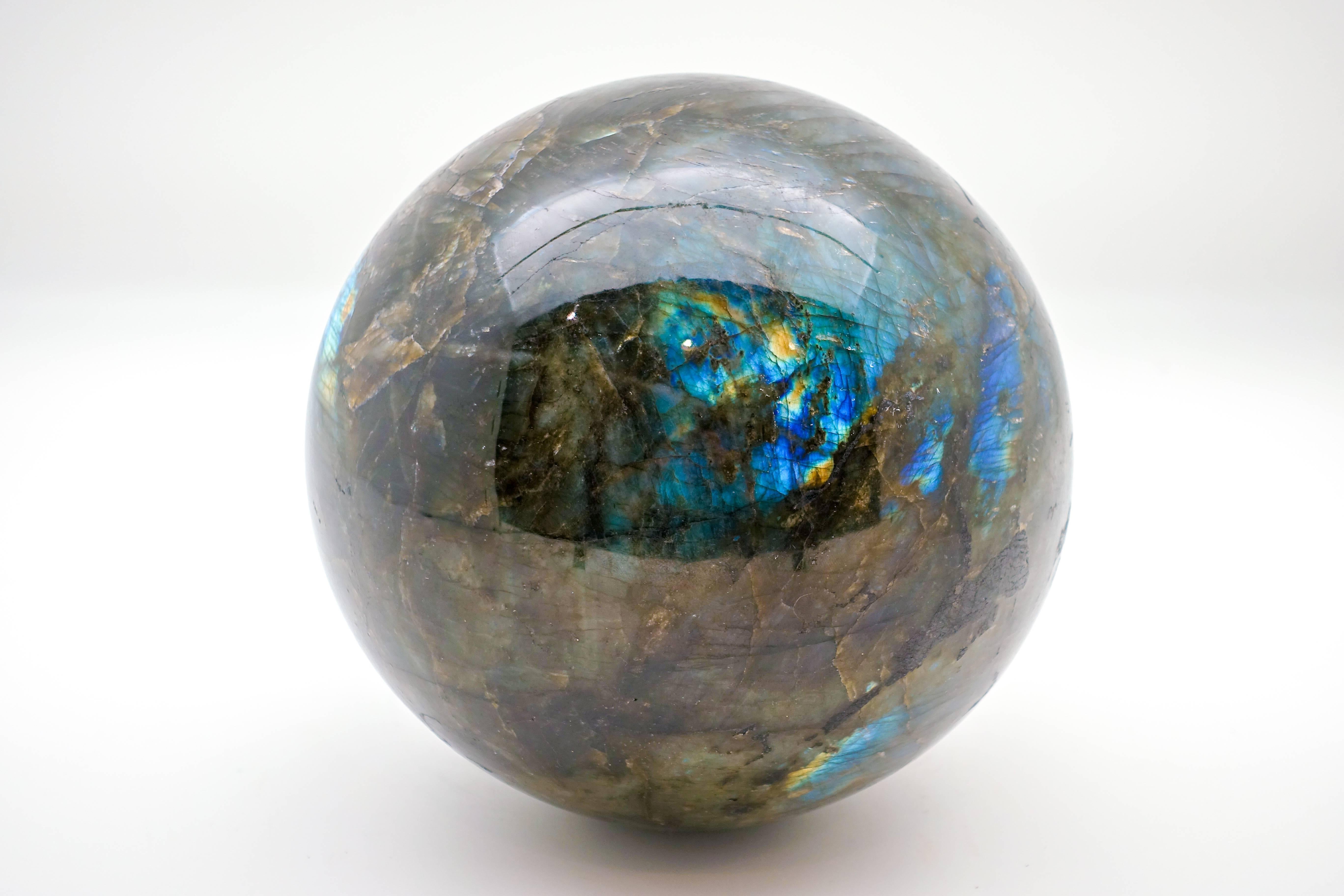Very Large Labradorite sphere, hand-carved in Madagascar. Labradorite is known for its flashy iridescence and color variations. Labradorite is also know as stone that will help you become the person that you are destined to be. It will cleanse your