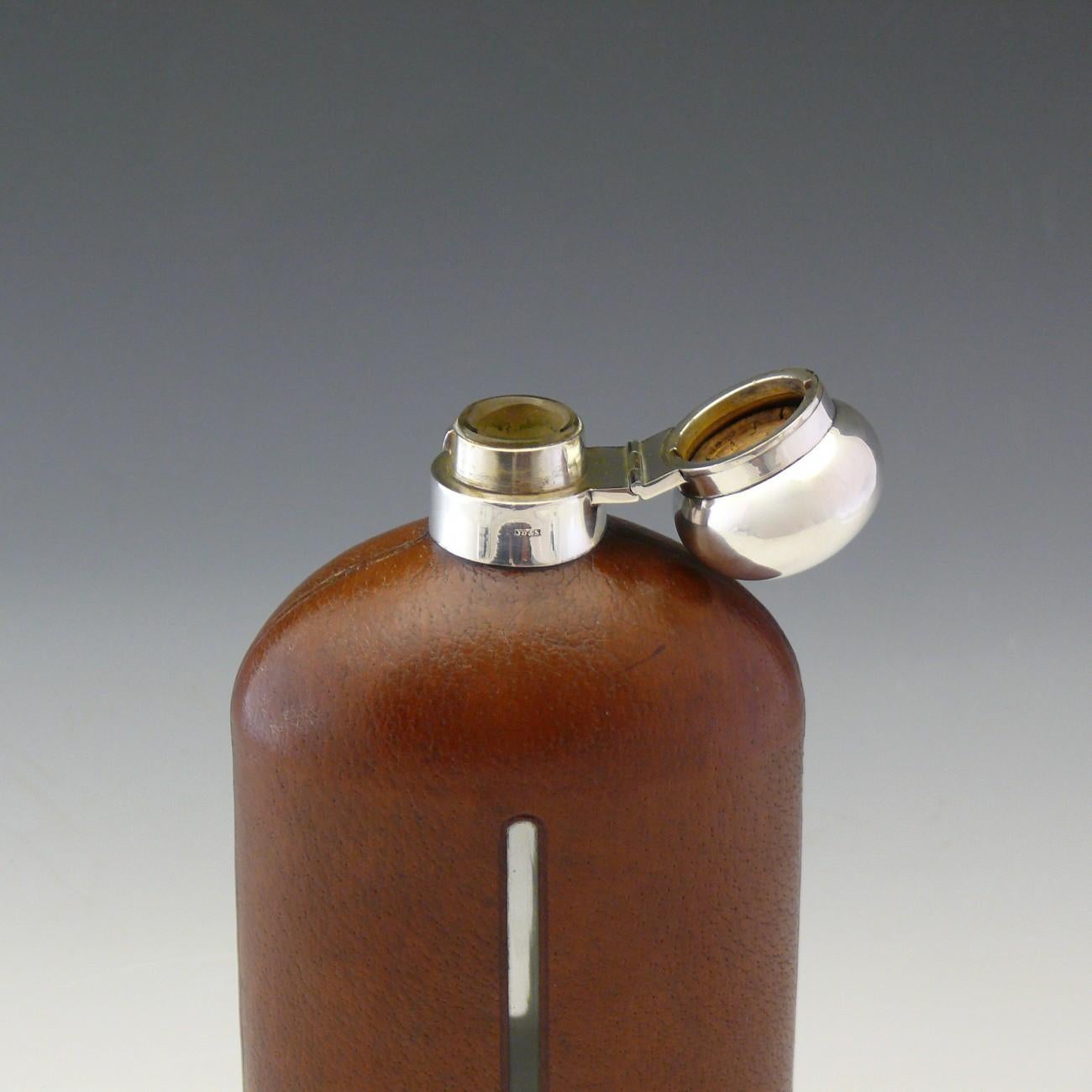 A very large pigskin leather and silver plate covered glass flask by James Dixon & Sons, circa 1910.

Dimensions: 28 cm/11 inches (height) x 11.5 cm/4½ inches (width).

Bentleys are Members of LAPADA, the London and Provincial Antique Dealers
