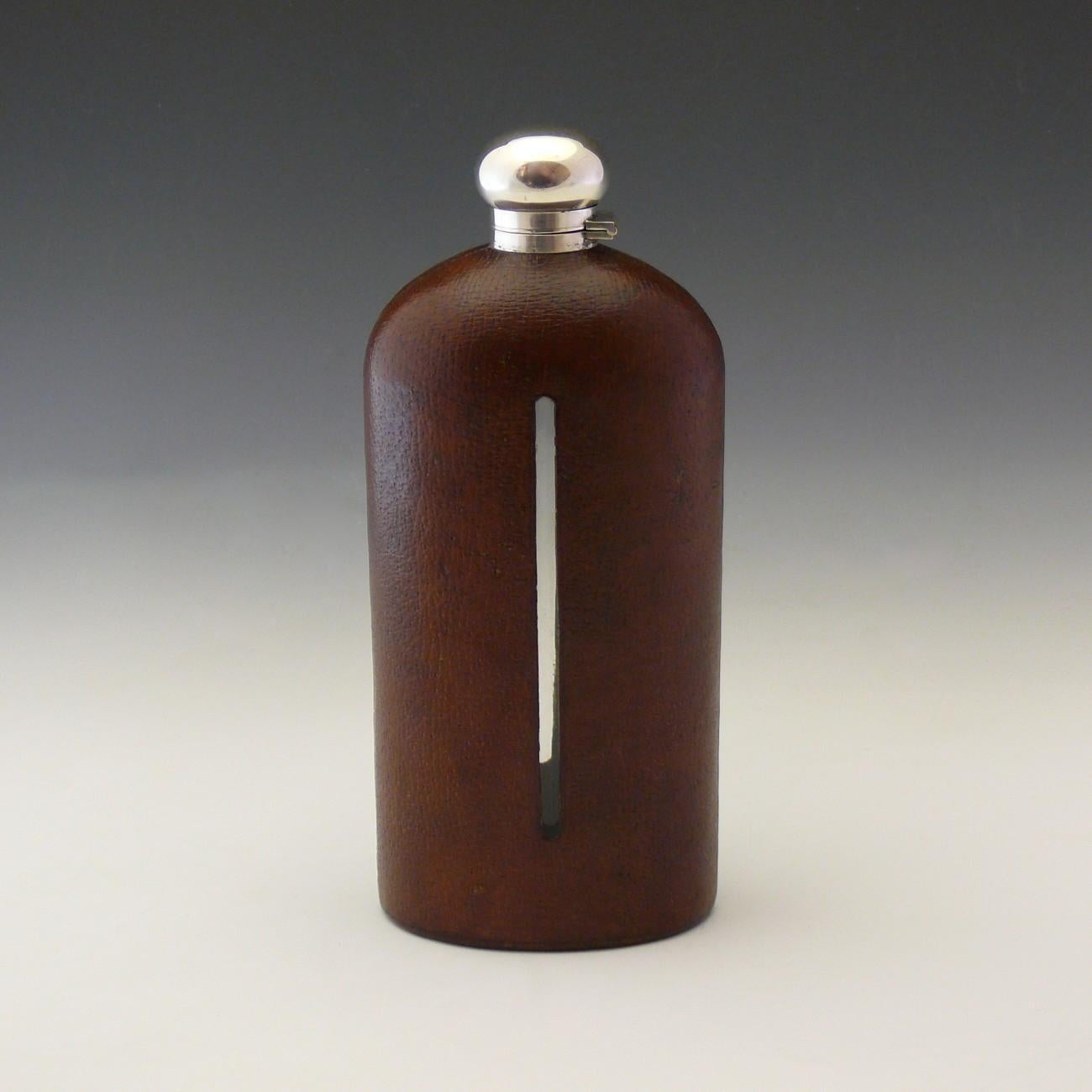 Very large pig skin leather covered glass flask with plated silver top of decanter size. Circa 1915.

Dimensions: 26.75 cm/10½ inches (height) x 11.5 cm/4¾ inches (width) x 7.5 cm/2? inches (thick).

 