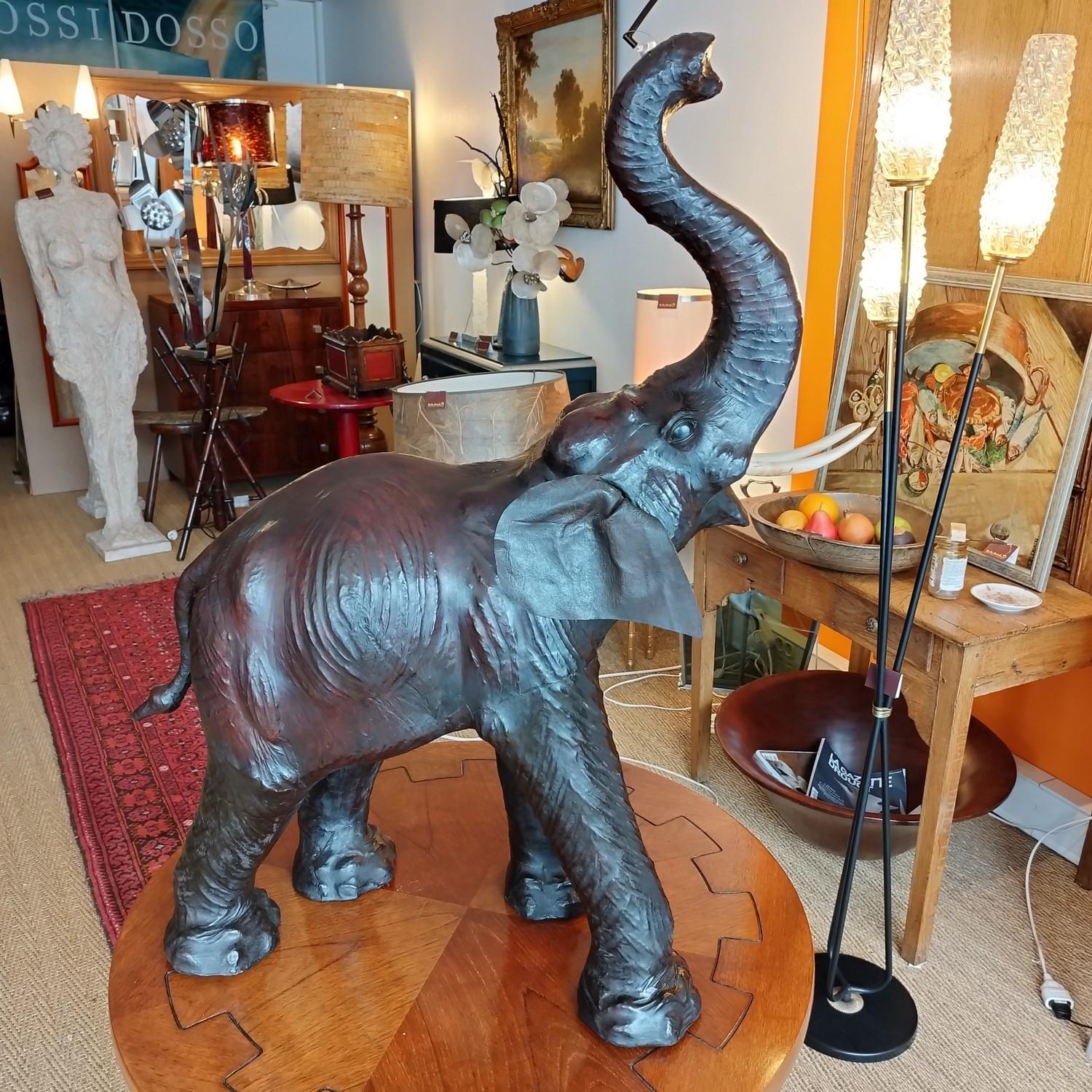 Beautiful very large leather elephant with wooden tusks from late 20th Century. Lovely colors and patina.

Do not hesitate to ask me for a shipping quote worlwide.