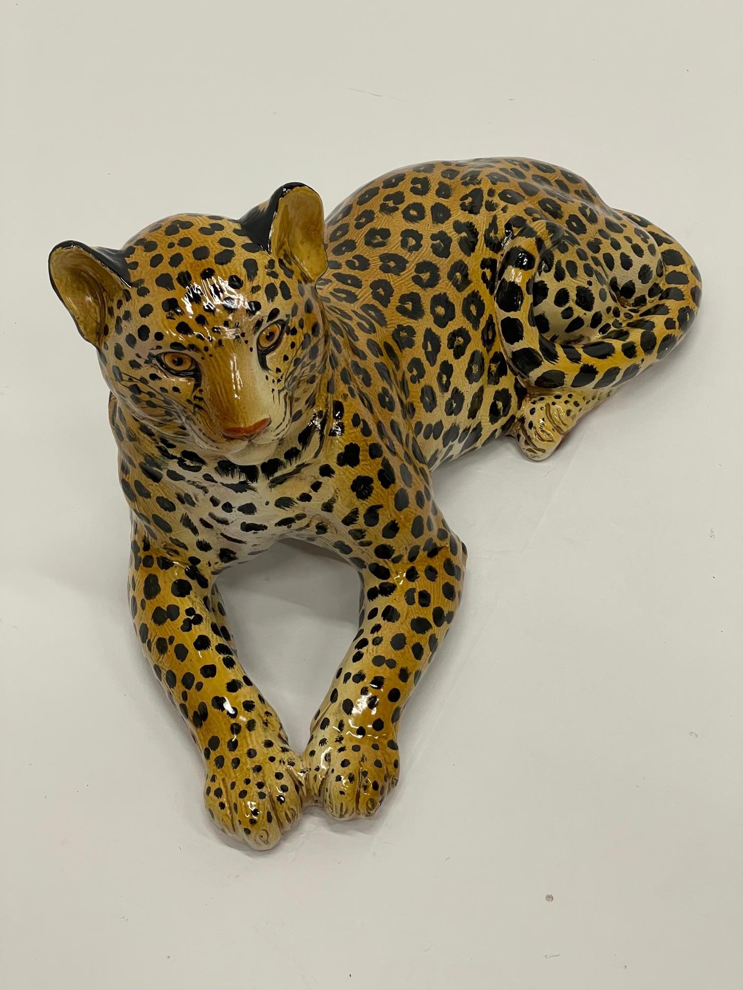 Large and striking hand painted Italian glazed terracotta sculpture of a leopard in repose.