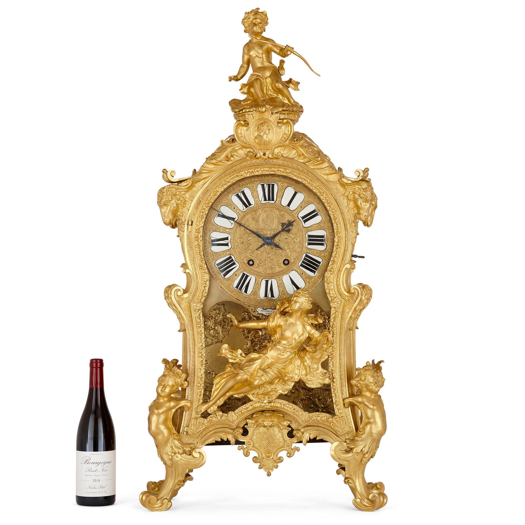 Very large Louis XV style gilt bronze mantel clock by Beurdeley
French, circa 1880
Measures: Height 102cm, width 48cm, depth 29cm

This very large mantel clock is a magnificent example of 19th century French decorative art by one of its very