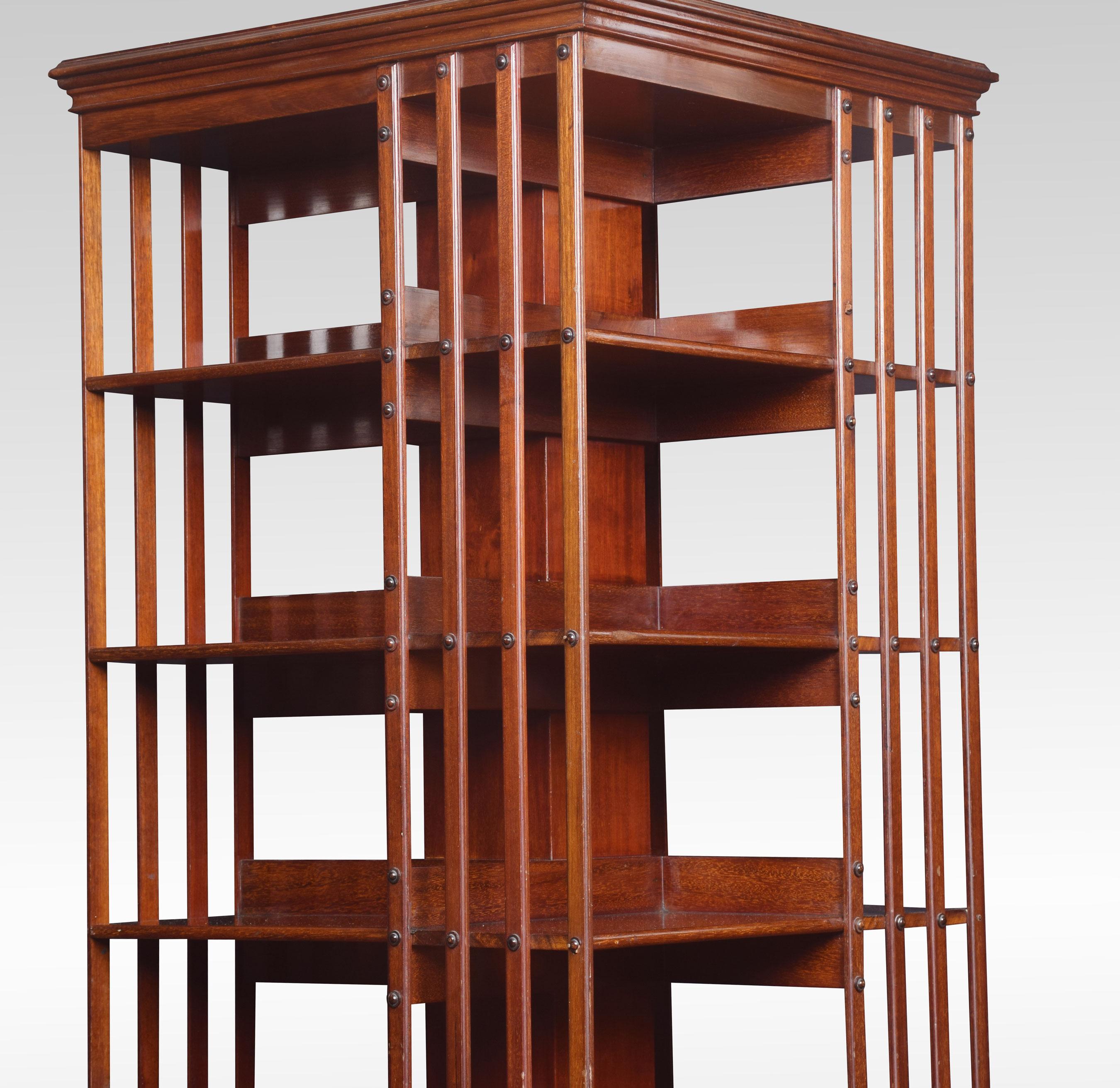 Very large mahogany revolving bookcase the square molded top above five tiers with an arrangement of shelves raised up on cruciform base terminating in ceramic castors.
Dimensions:
Height 66 inches
Width 24 inches
Depth 24 inches.