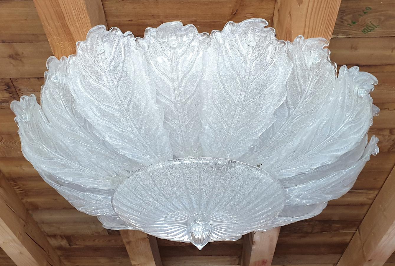 Very large Mid-Century Modern clear and translucent leaves Murano glass flush mount chandelier, by Barovier & Toso, Italy, 1970s.
8 lights, rewired for the US.
Frame in painted metal.
Excellent condition of the glass, some signs of wear on the