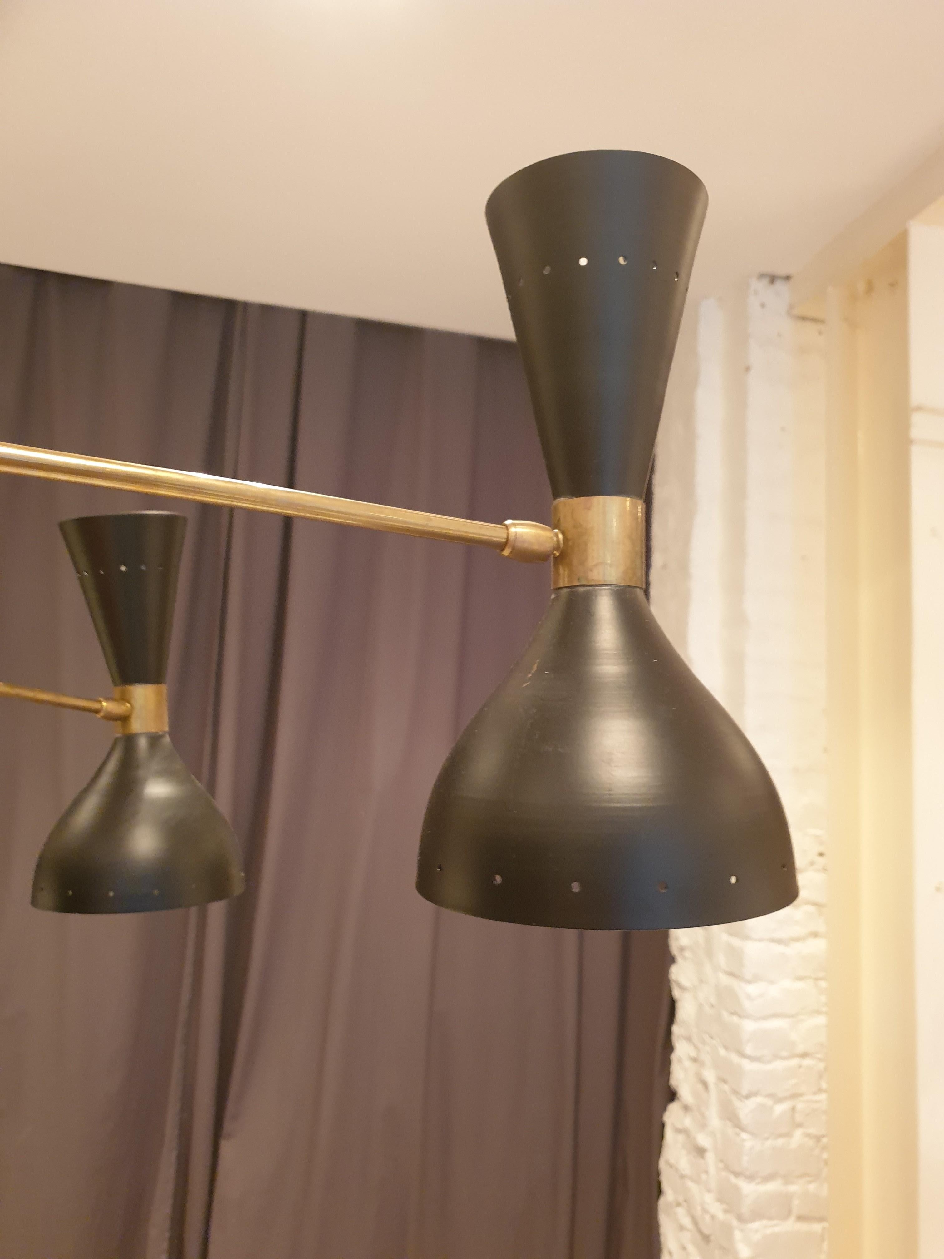 Well sized brass and black lacquered chandelier in the manner of Stilnovo.
