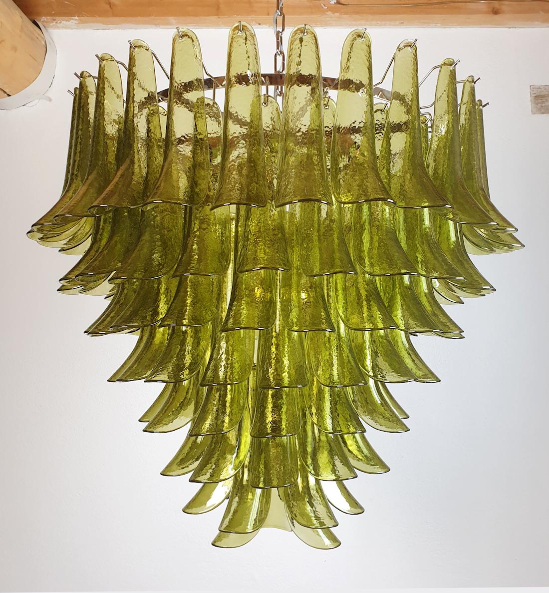 Vintage Green Murano glass very large chandelier, by Mazzega Italy late 1970s.
The Mid-Century Modern Murano chandelier has seven tiers of delicate handmade petal glasses, and a nickel frame.
The chandelier has 12 lights, rewired for the US.
It