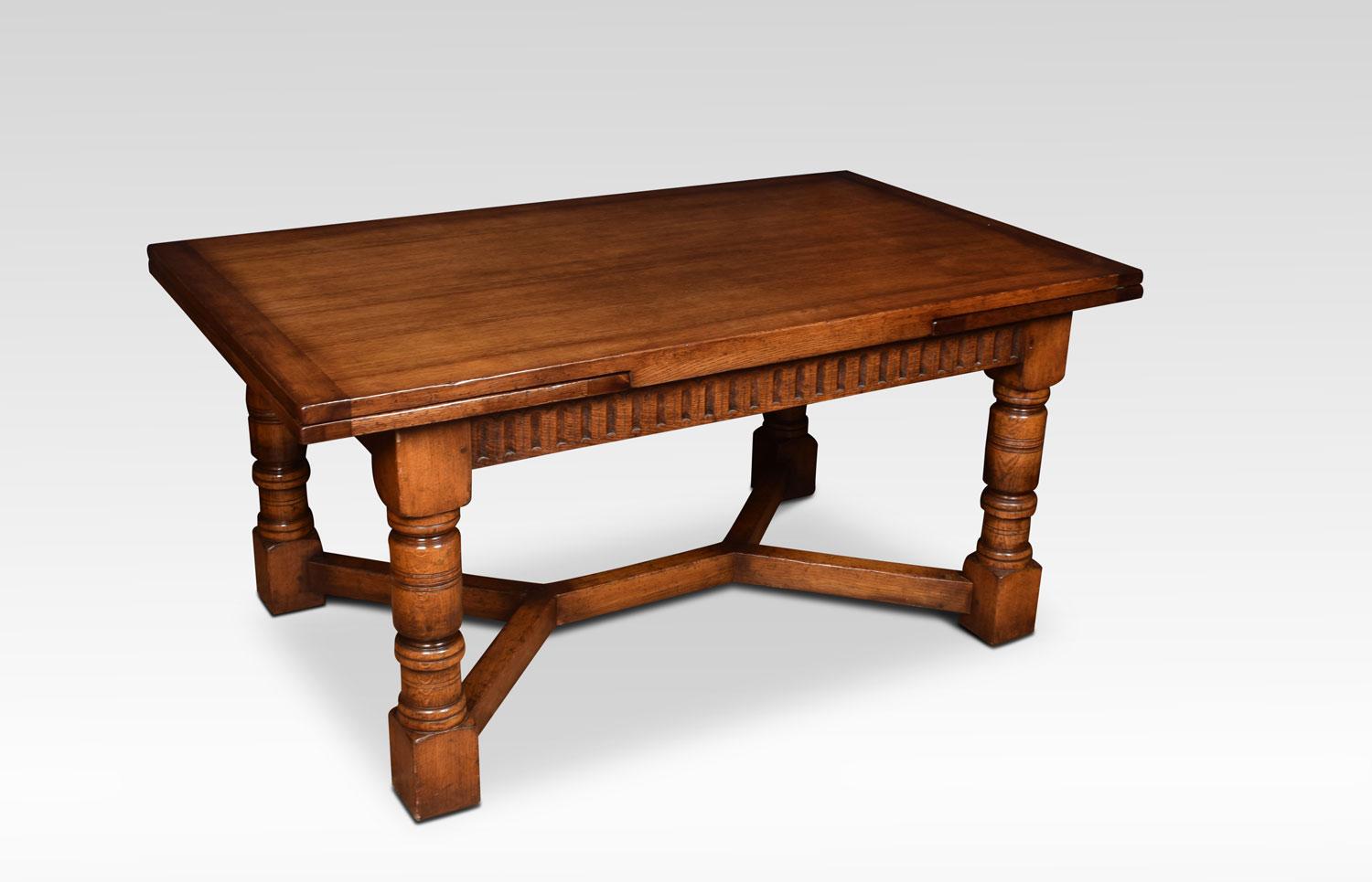 Oak draw leaf refectory table, the rectangular solid oak top above two pullout / pull-out ends, to the ed frieze above massive turned gun barrel legs joined by a double Y-shaped stretcher.
Dimensions
Height 30.5 inches
Width 66 inches when open