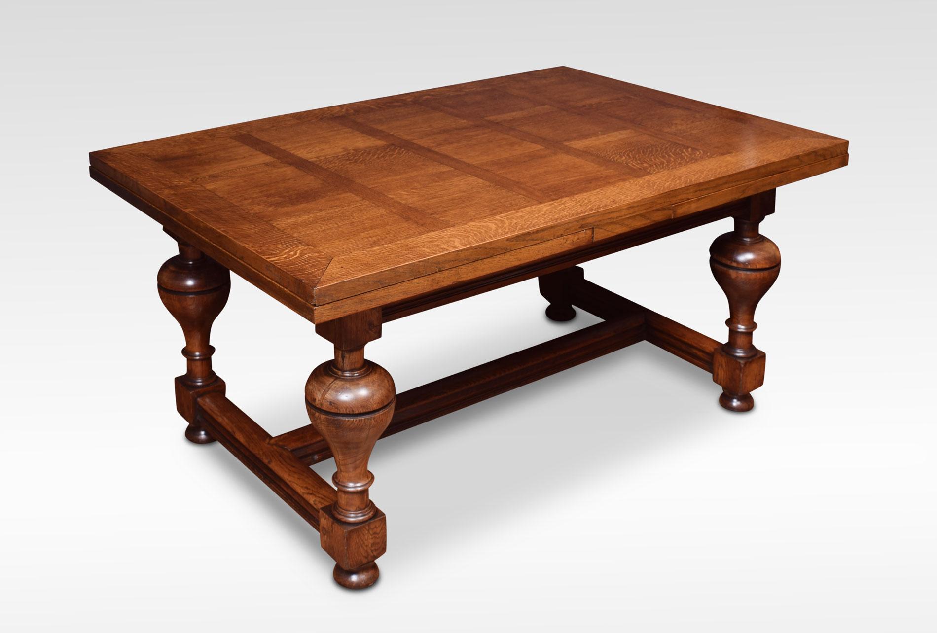Oak draw-leaf refectory table of generous proportions. The thick parquetry top having pull-out leaves to each end above moulded frieze raised on bulbous legs leading down to bun feet united by H stretcher. Will seat 10 people comfortably.
Measures:
