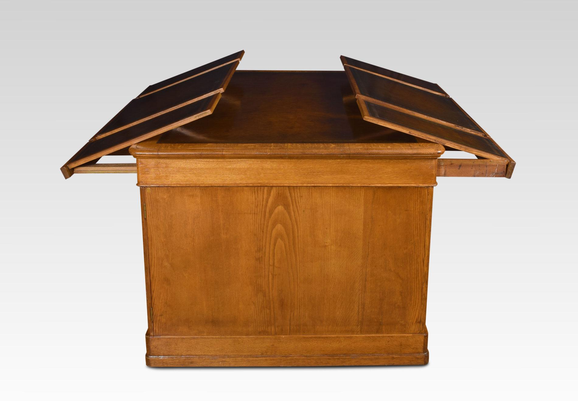 Tall oak partners/library desk the rectangular hide top with a gilt-tooled border enclosed by a moulded edge over an arrangement of six freeze drawers all fitted with leather writing slopes. Above two large pedestals having three draws to each
