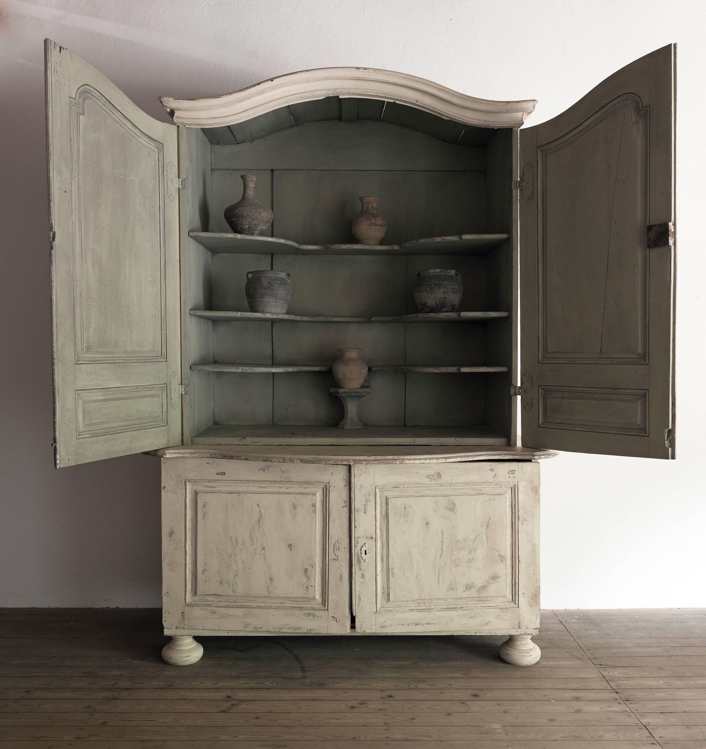 An impressive large painted cupboard with partly original paint. Found in a castle, where it had been installed in the dining room as part of the boiserie. 

 